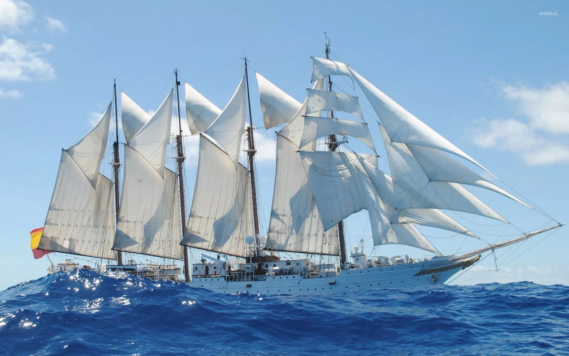 Sailing ship on the wavy sea wallpaper
