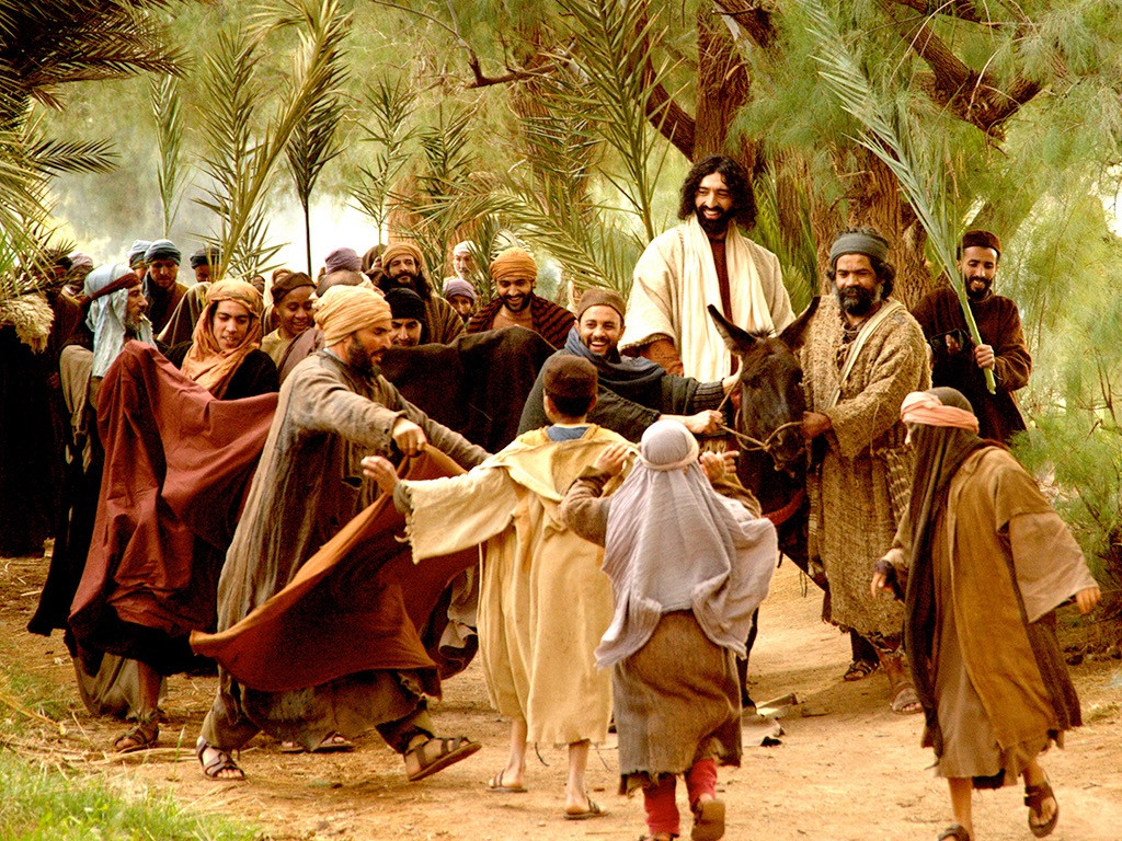 Jesus rides triumphantly into Jerusalem