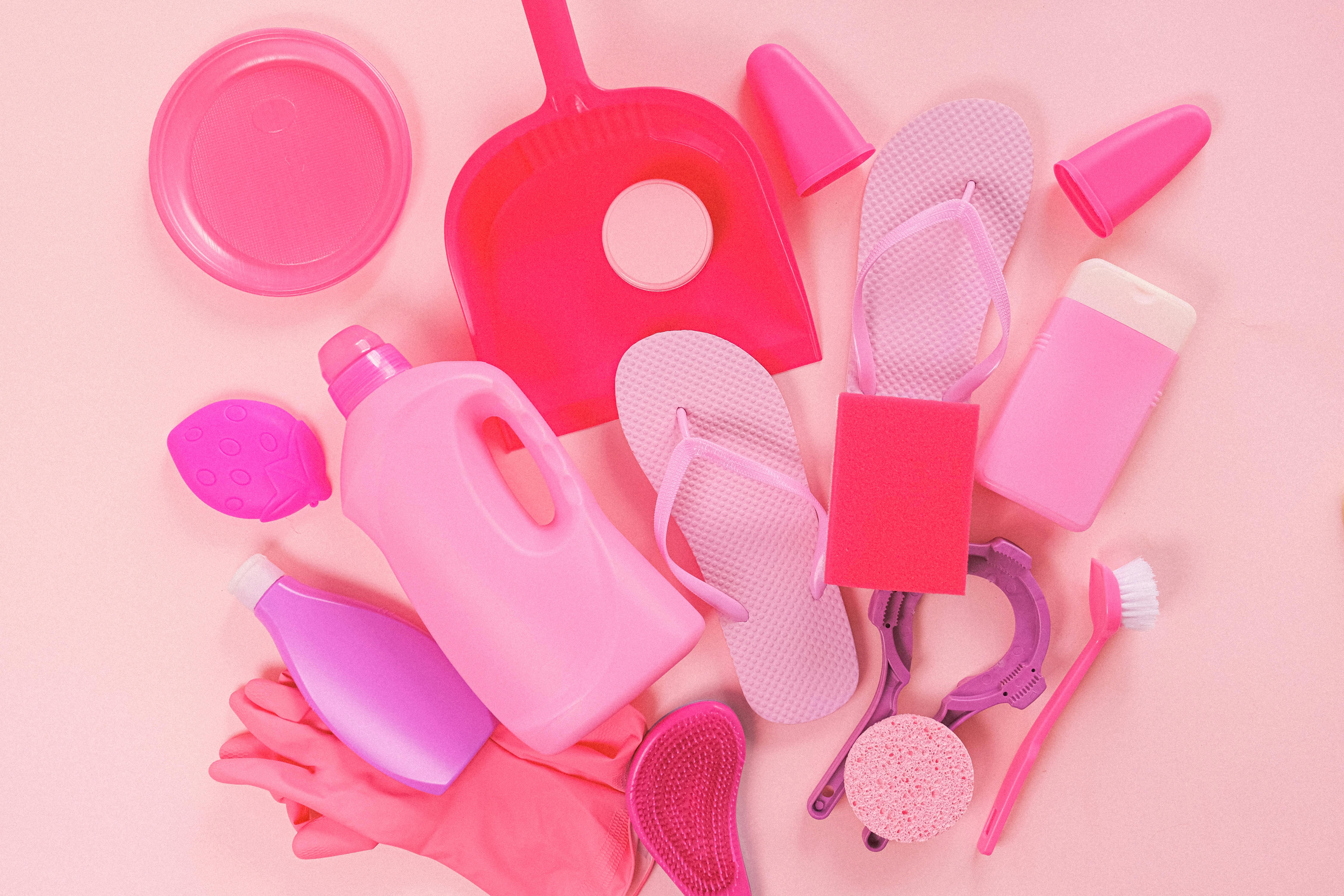 cleaning supplies on pink background