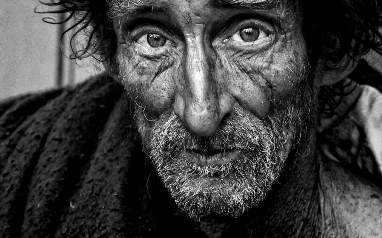 Portrait of an old homeless man