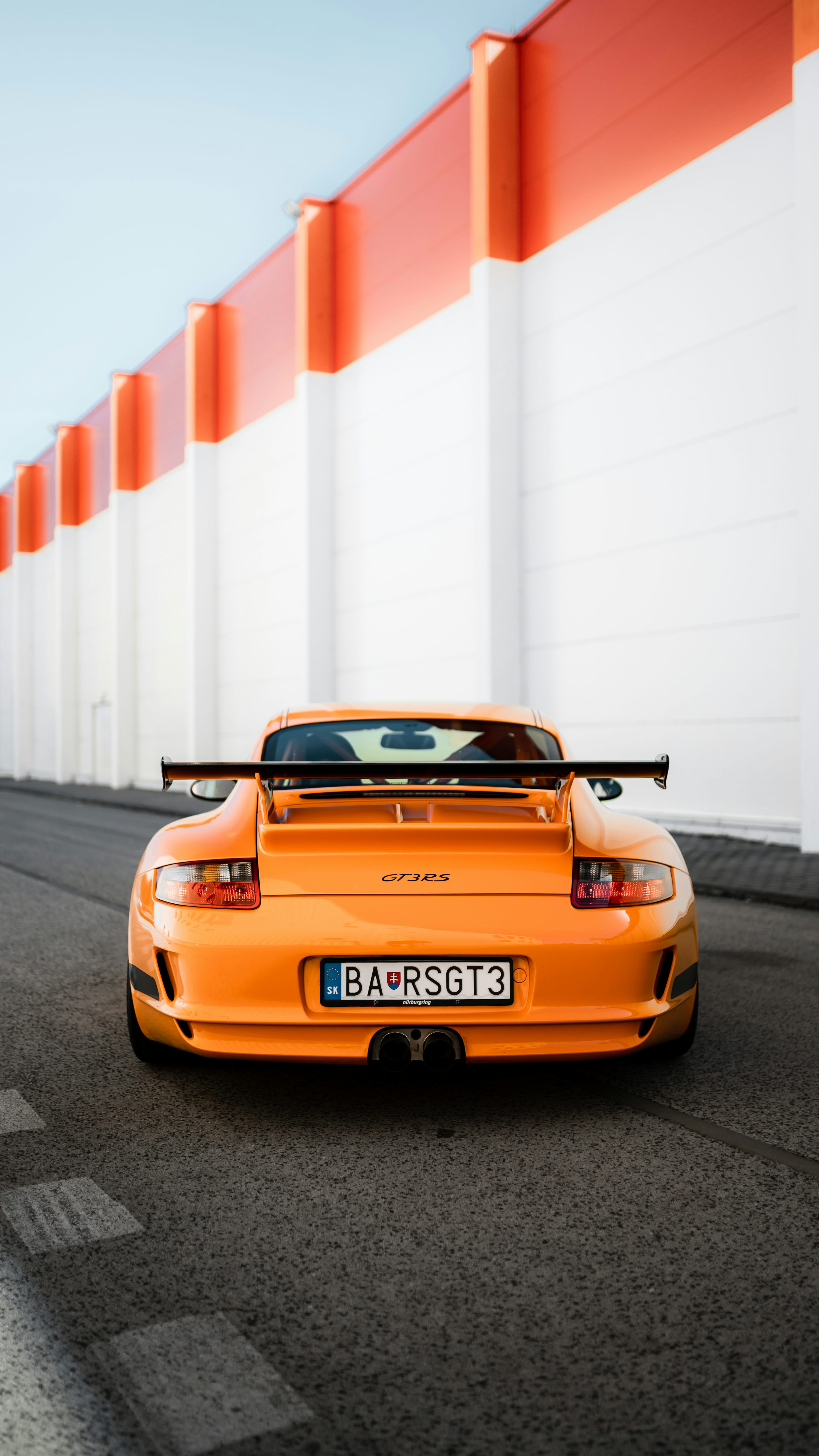 Orange porsche 911 on road during