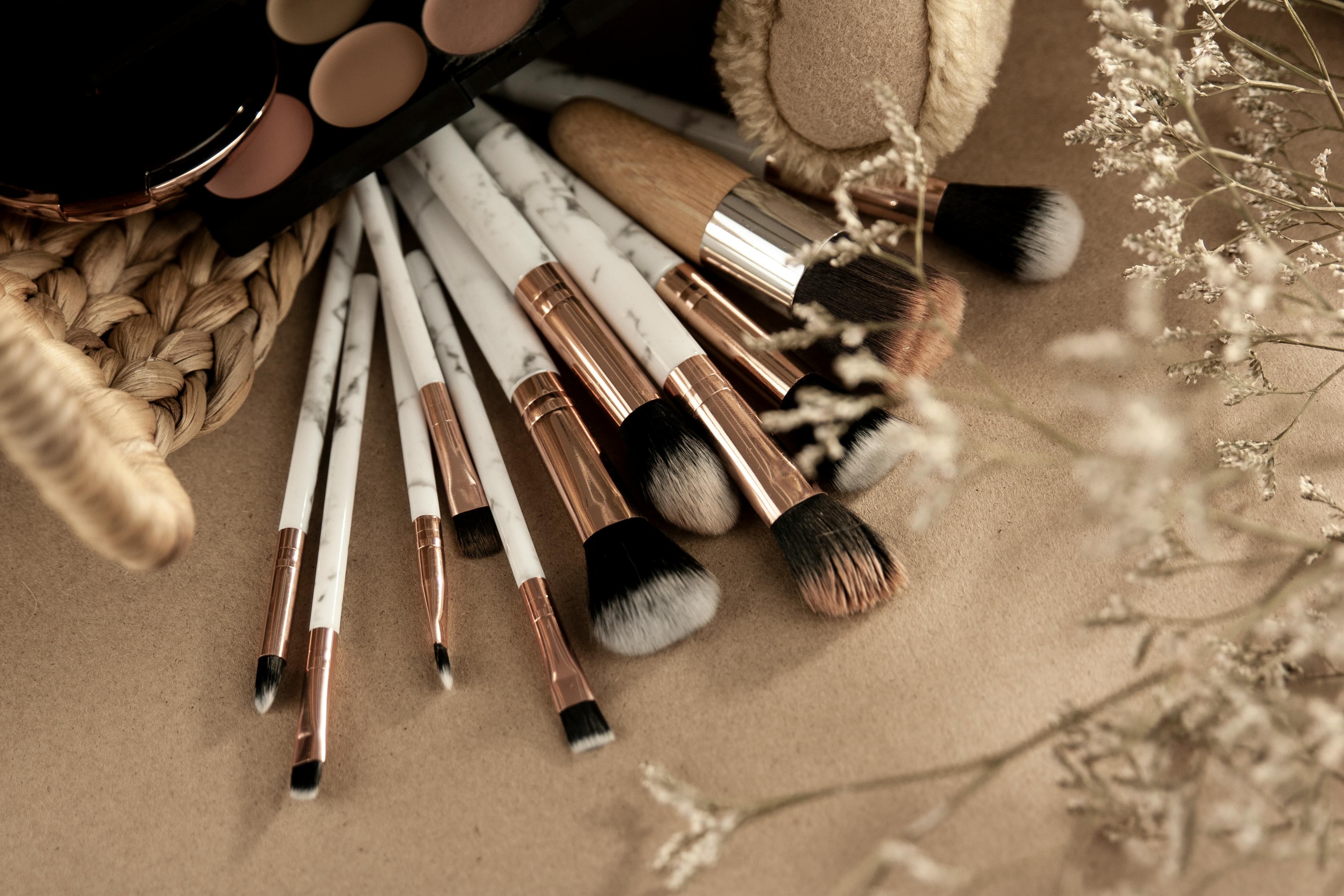 Makeup brushes with eyeshadows on beige