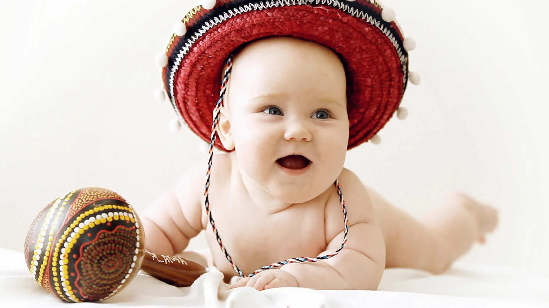 Baby in sombrero hat with maracas
