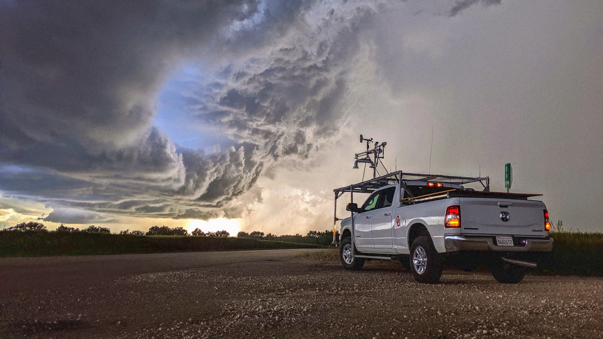 Storm Chasing Trucks Behind Twisters