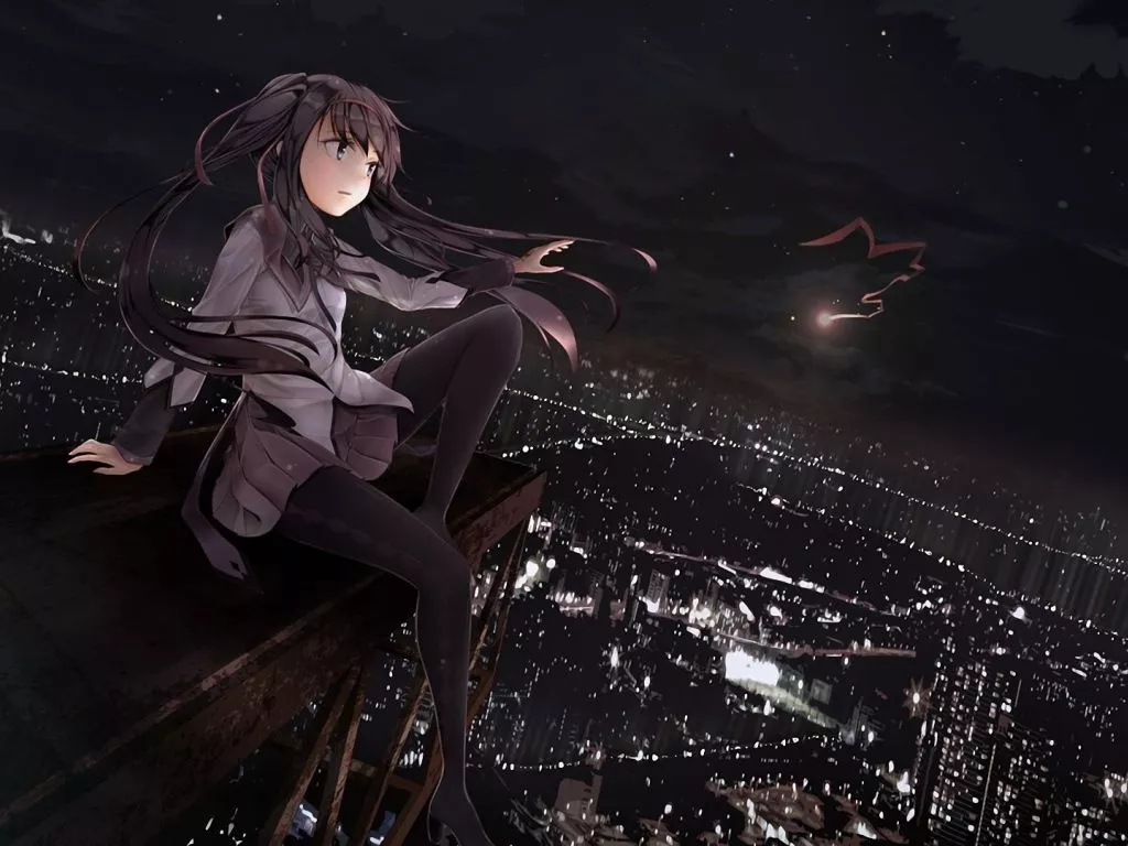 The girl looks at the city at night