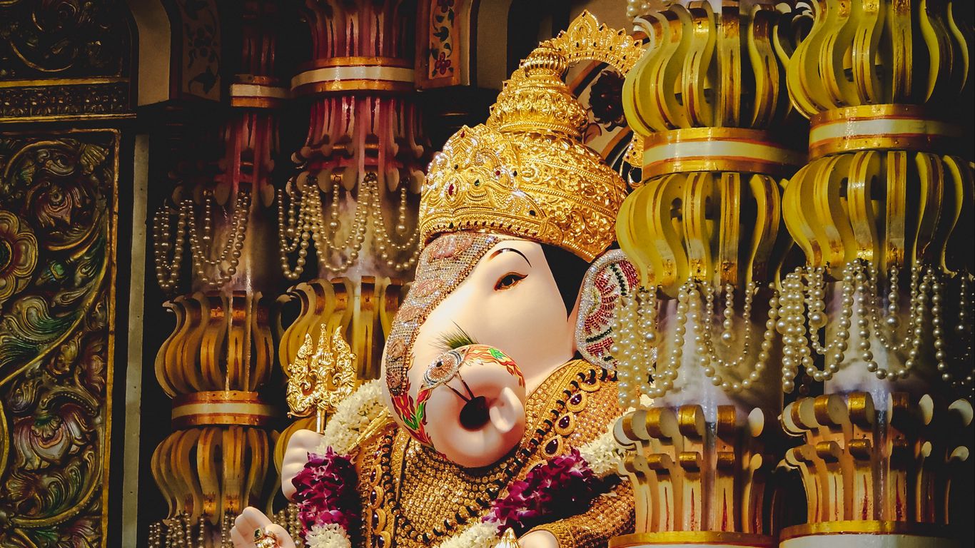 Download wallpaper 1366x768 ganesha, deity, god, religion, statuette, columns, golden tablet, laptop HD background