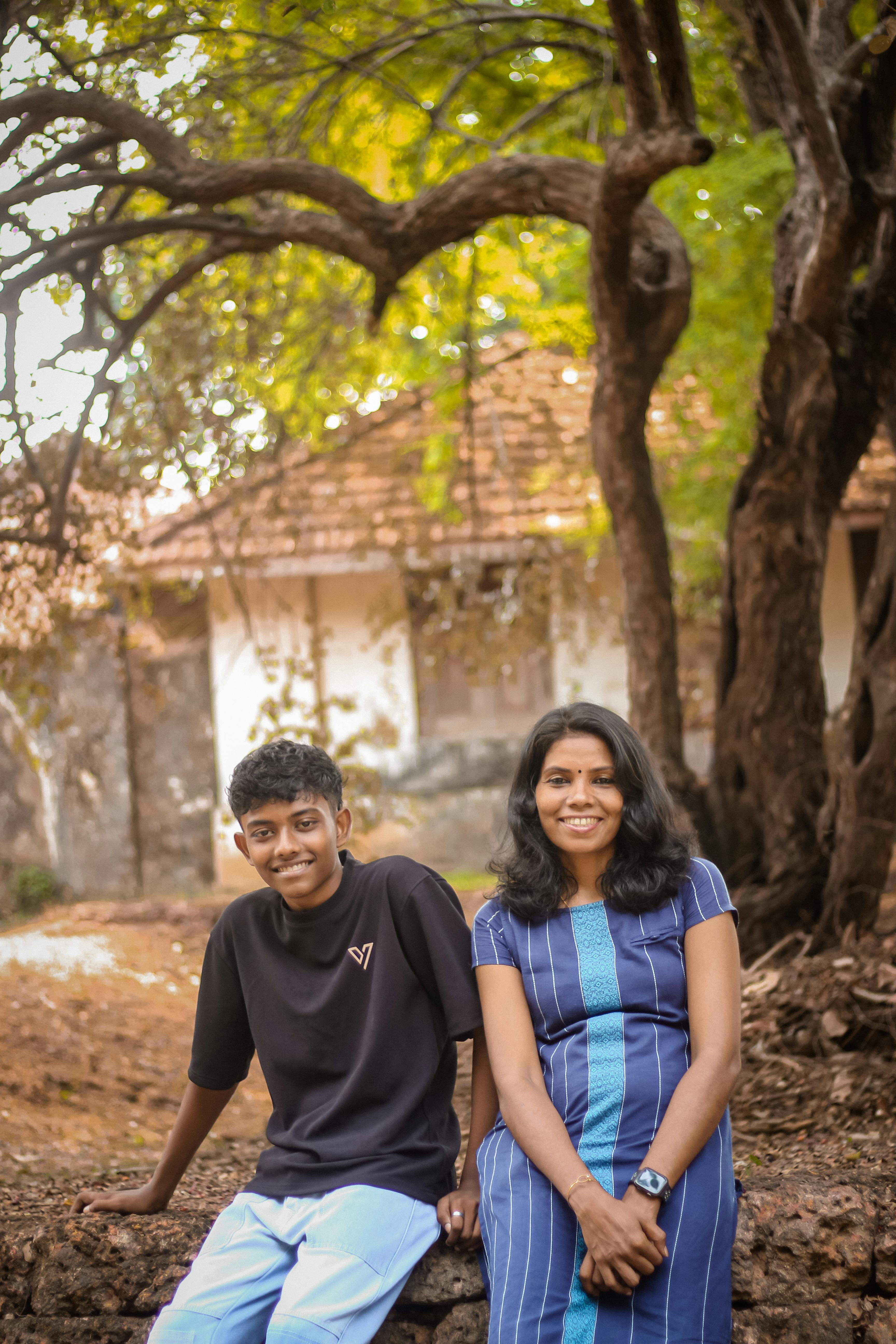 A Girl and Boy Sitting Outdoors