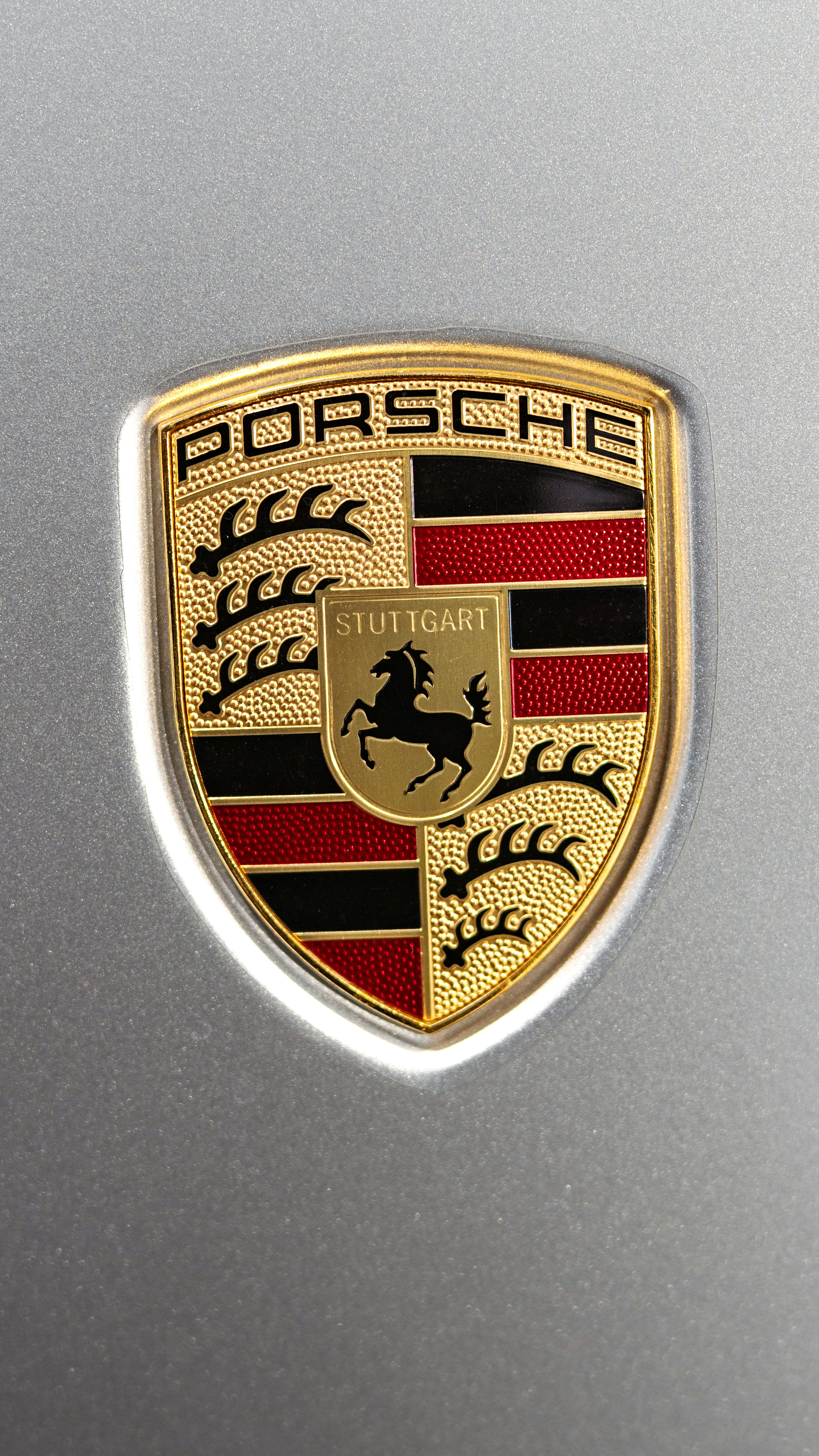 A close up of a porsche emblem on a car