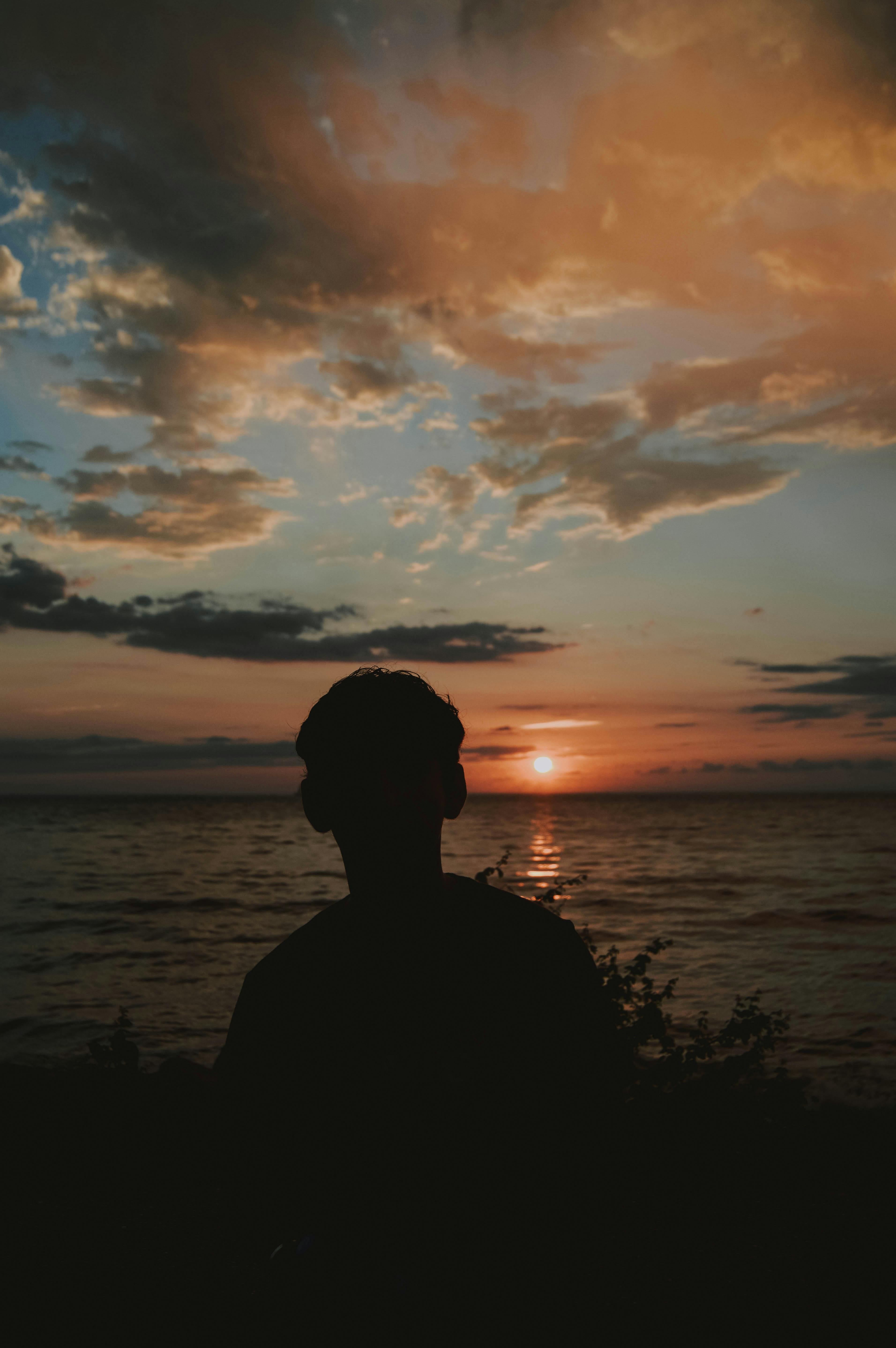 Silhouette Photography of Man Near Body of Water · Free