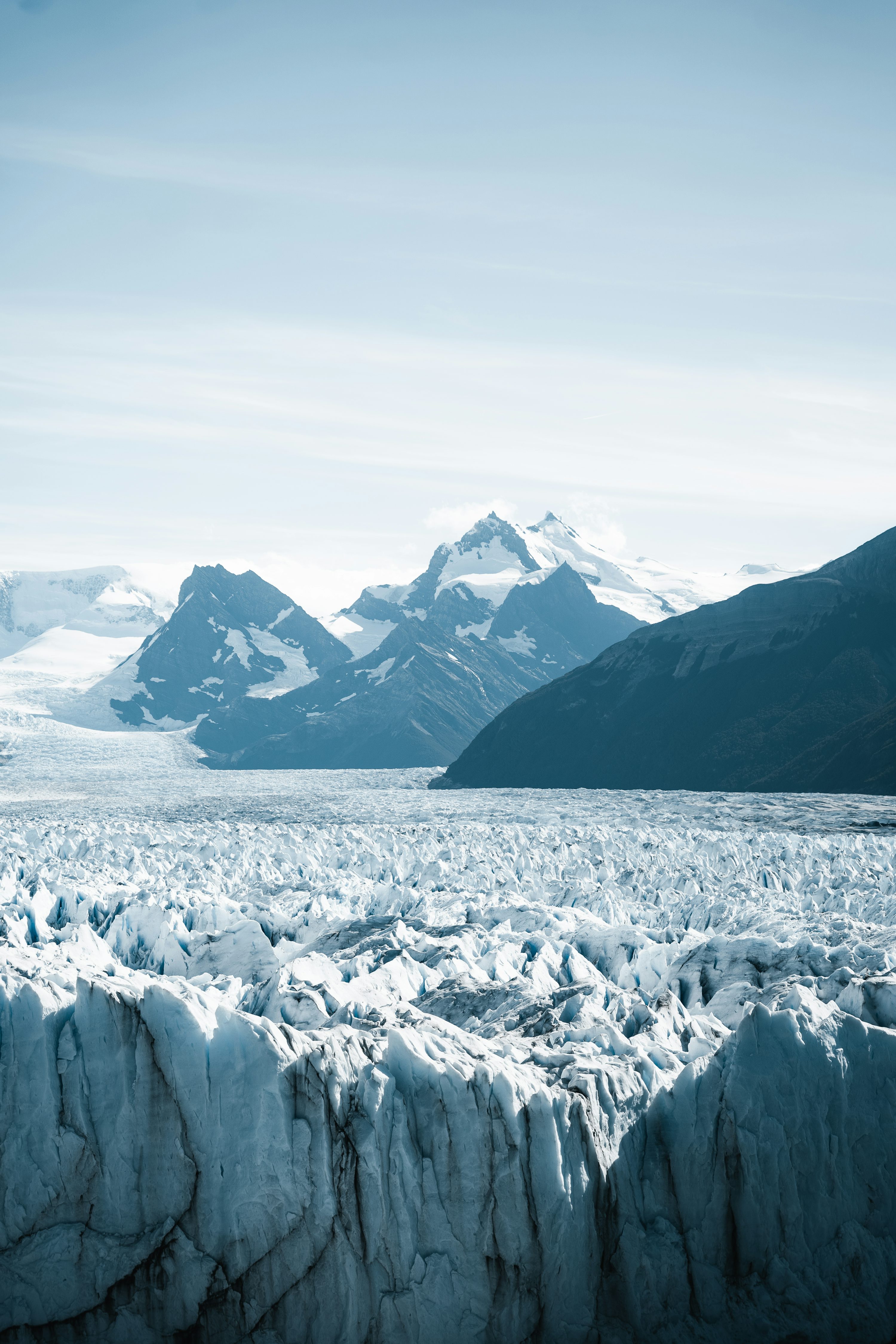A large glacier with mountains in