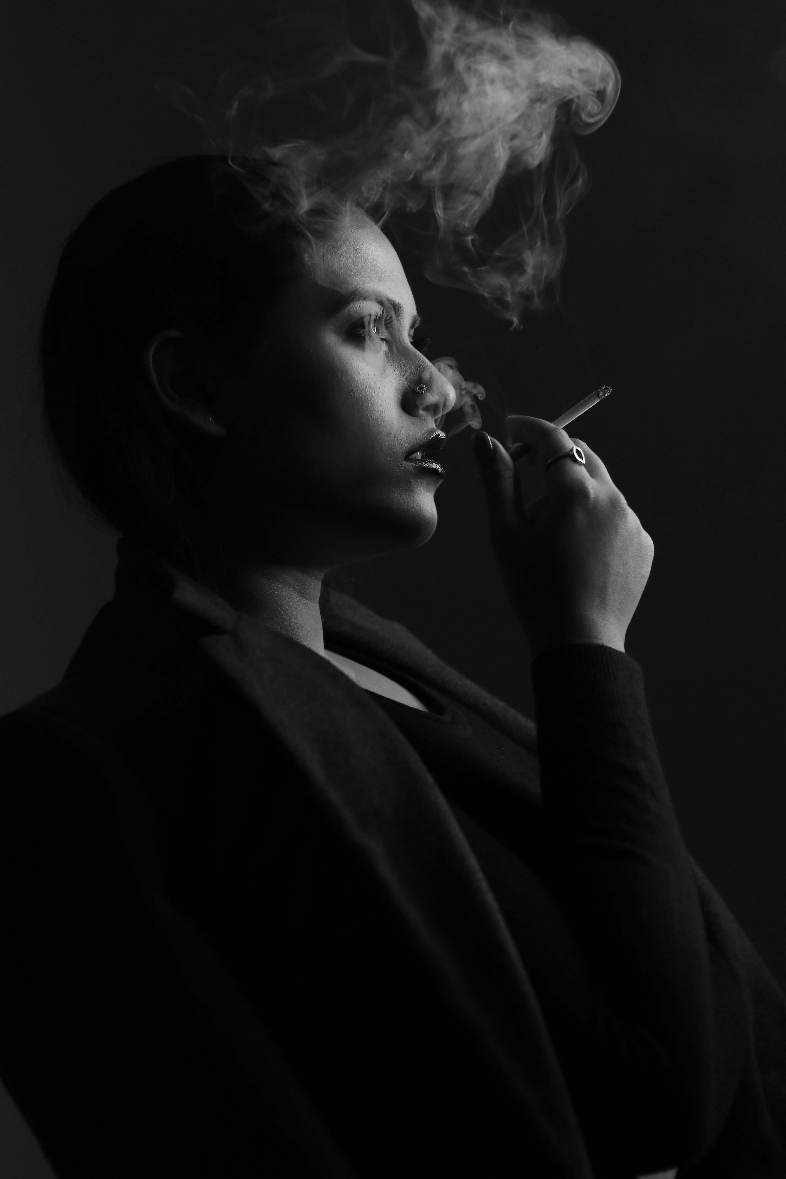 Grayscale photo of woman smoking