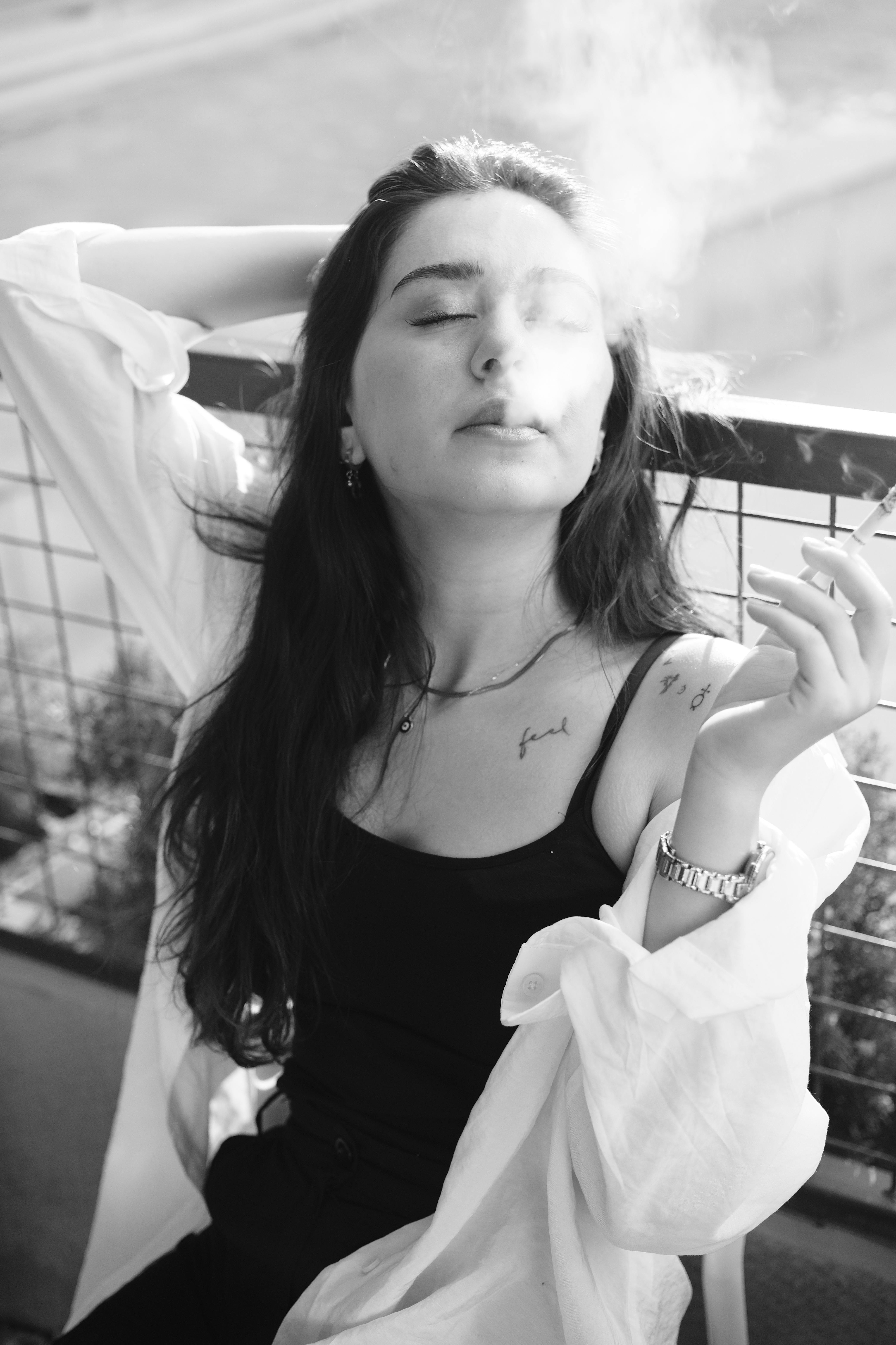 Woman Smoking Cigarette in Black