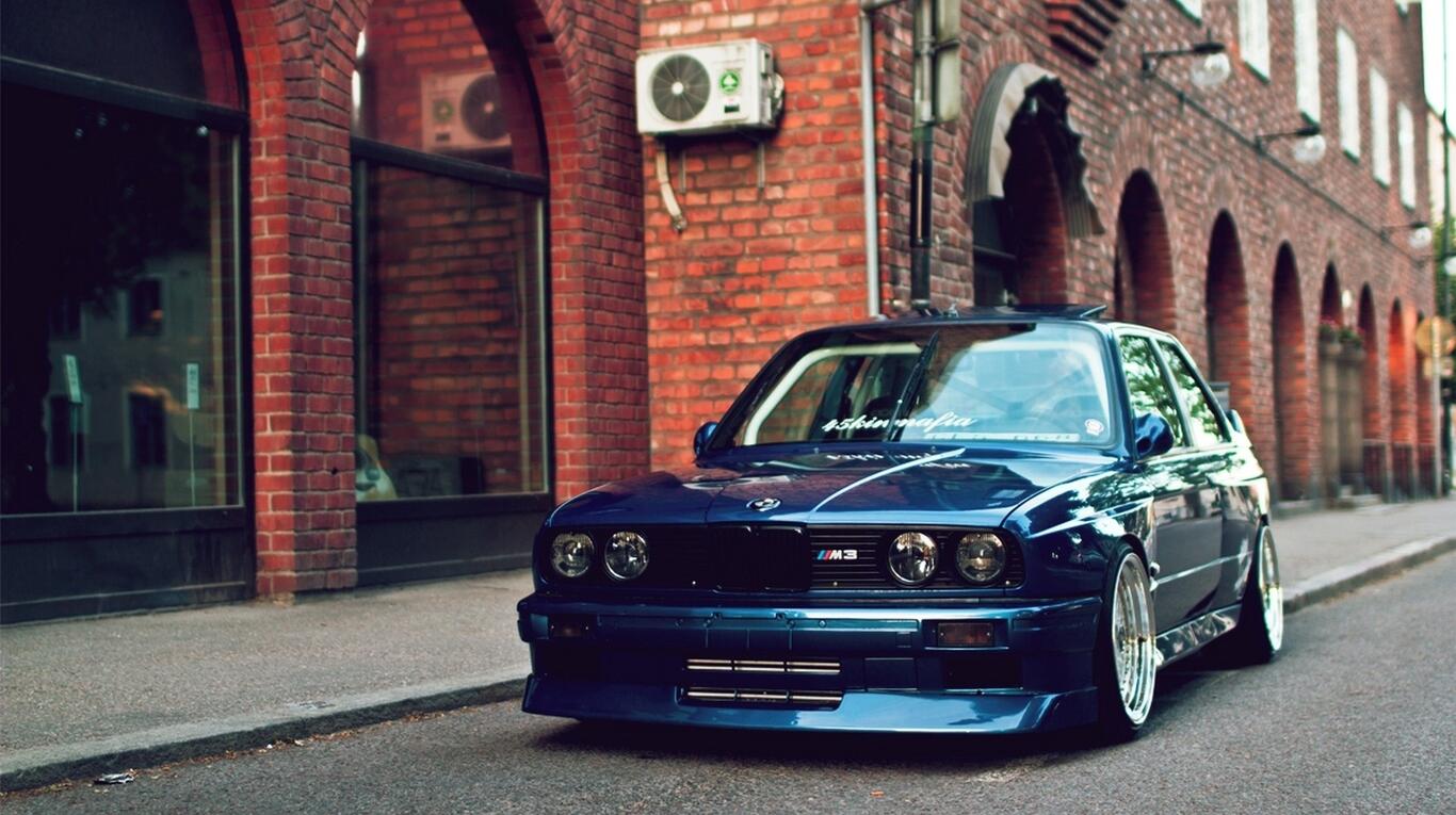 An old bmw m3 in blue is standing