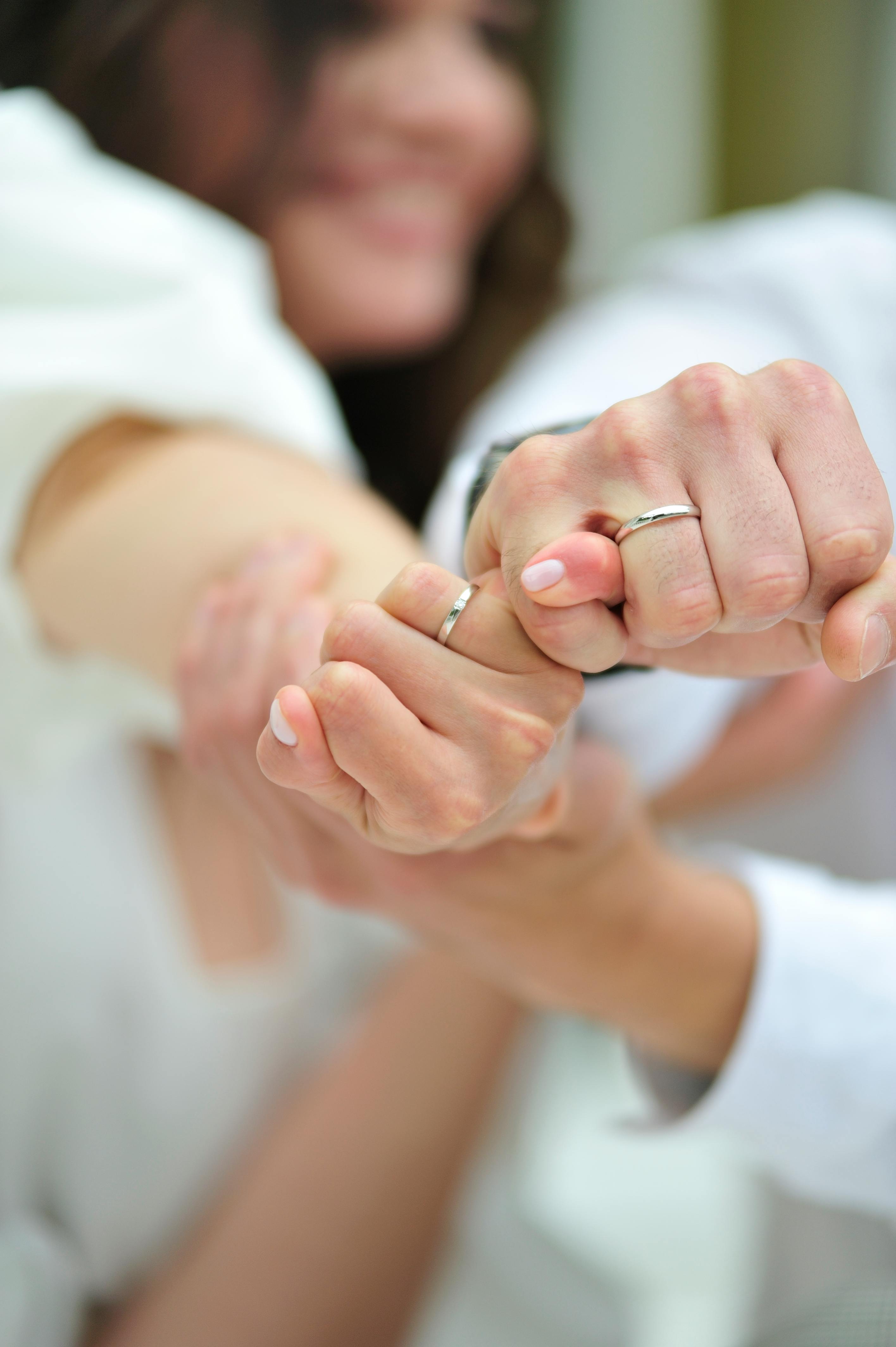 Couple with Wedding Rings Holding Hands