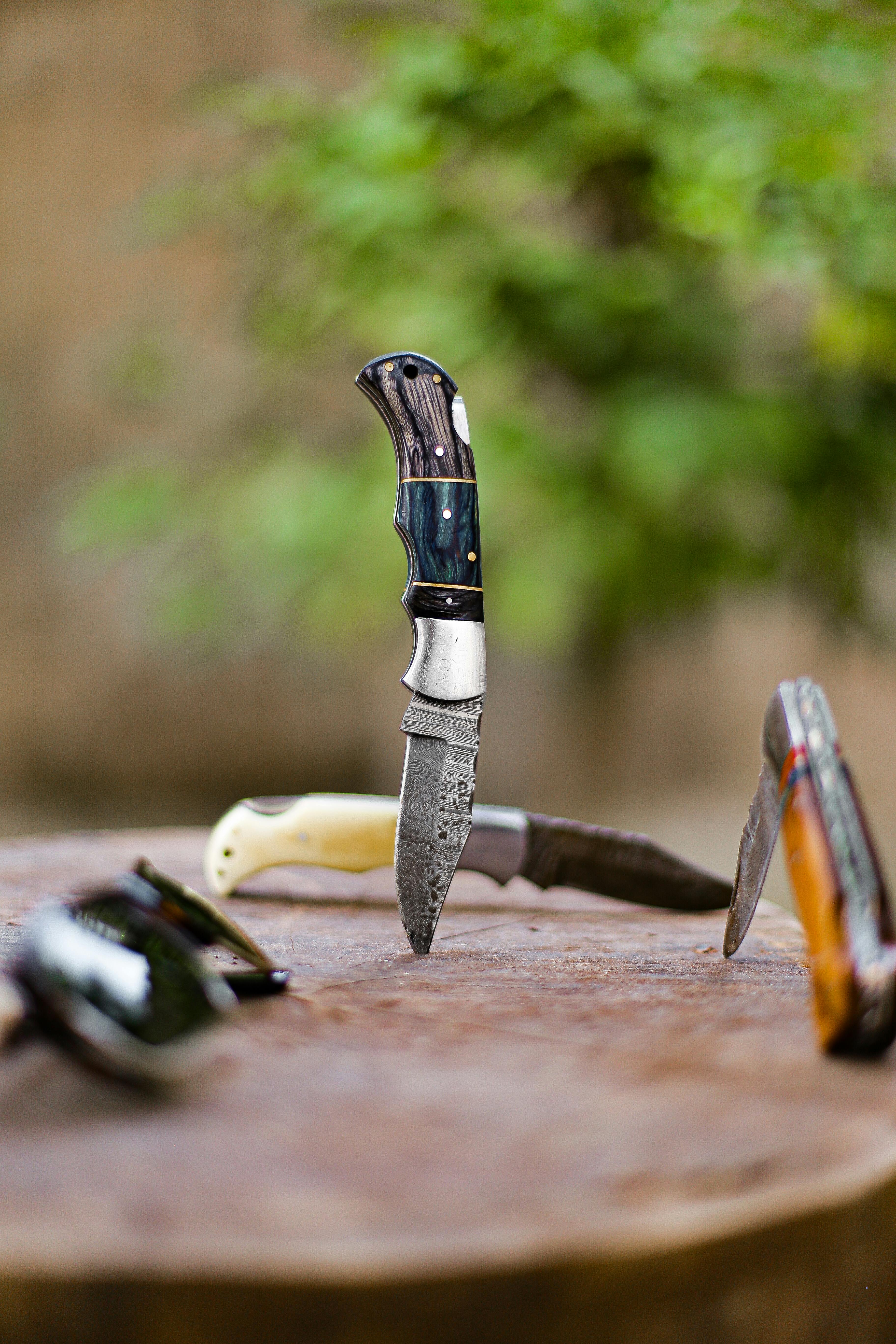 Pocket Knives on Wood · Free