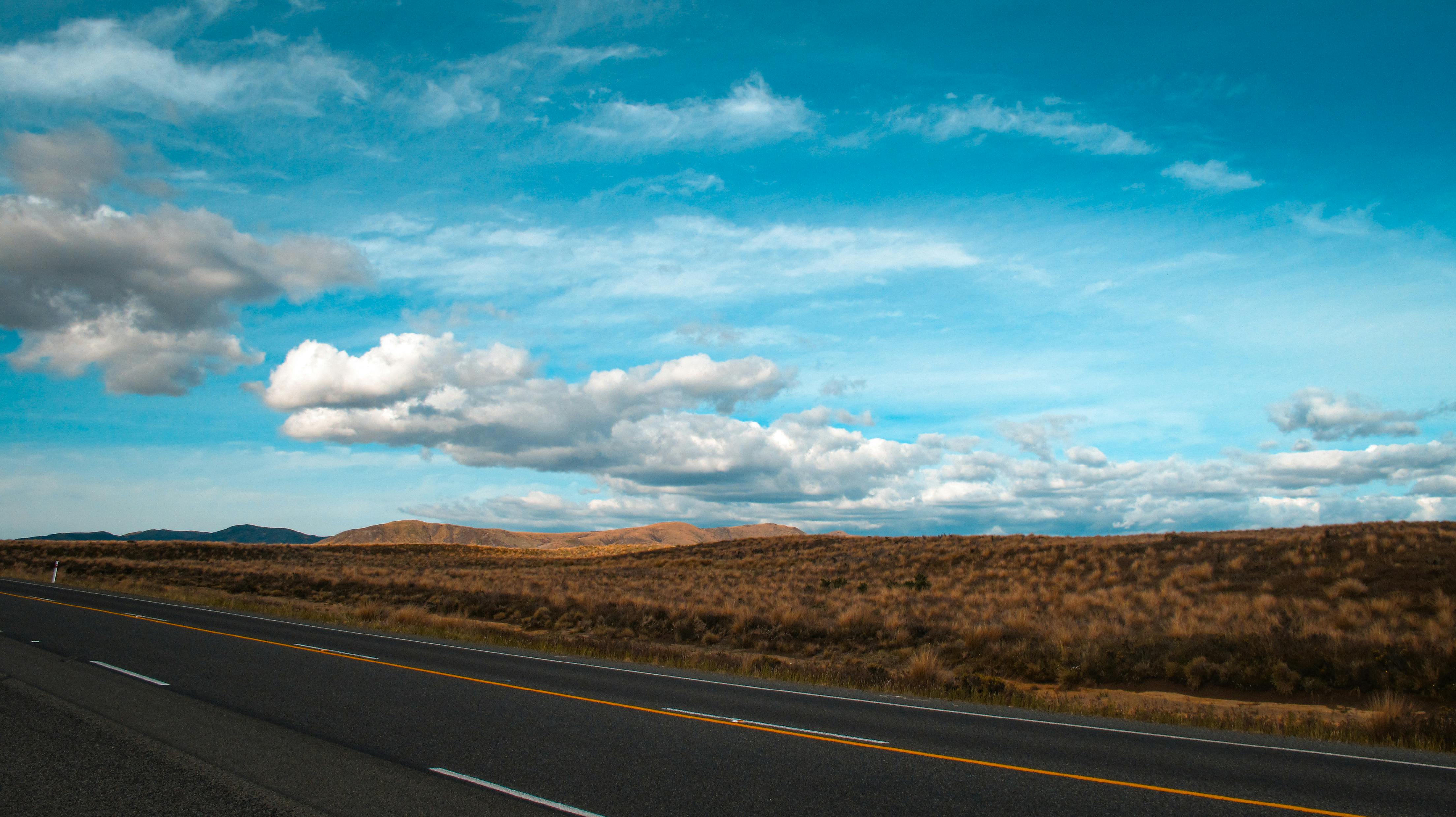 Asphalt Road Under Blue Sky and White