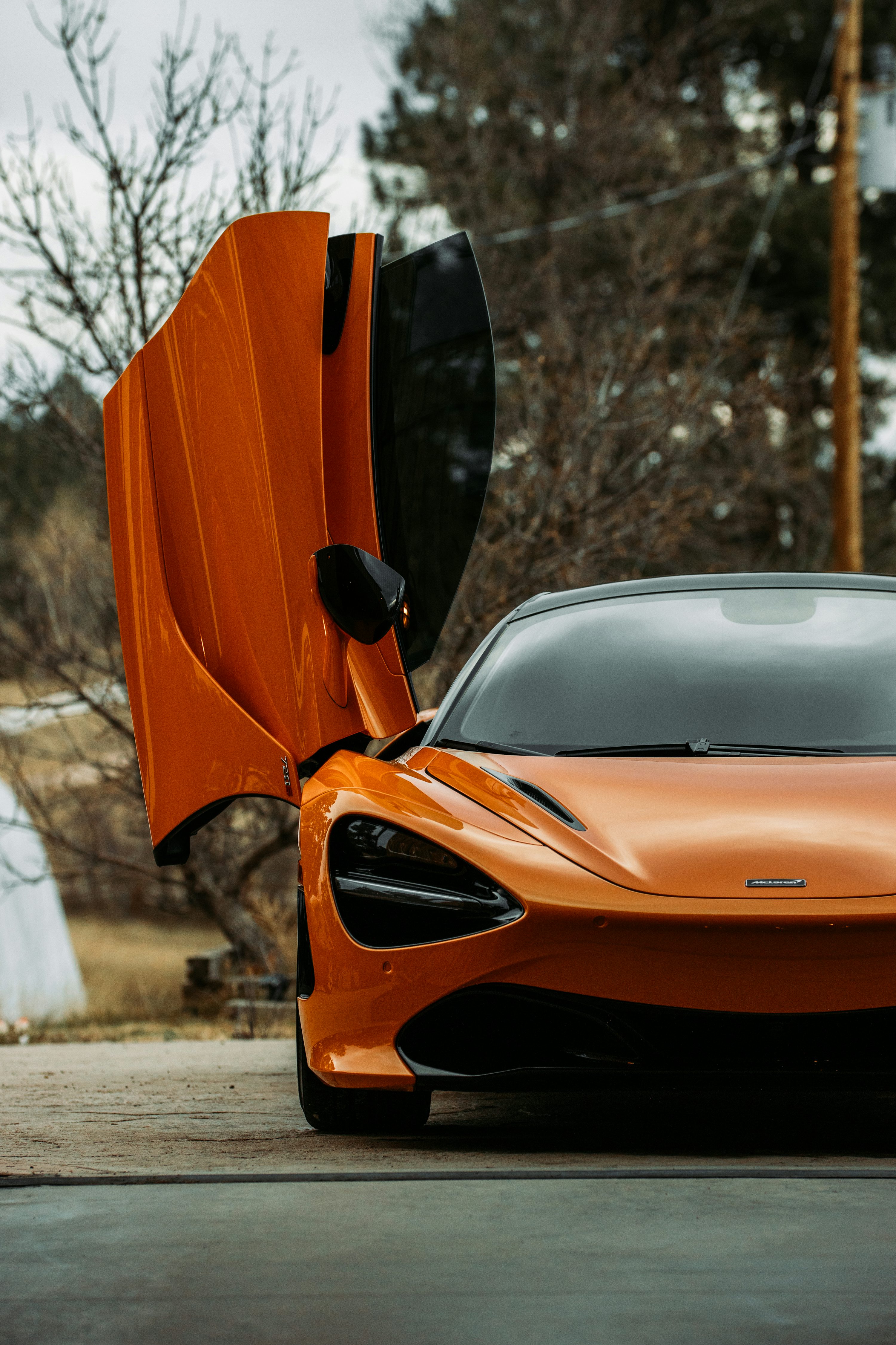 Orange car on road during daytime photo