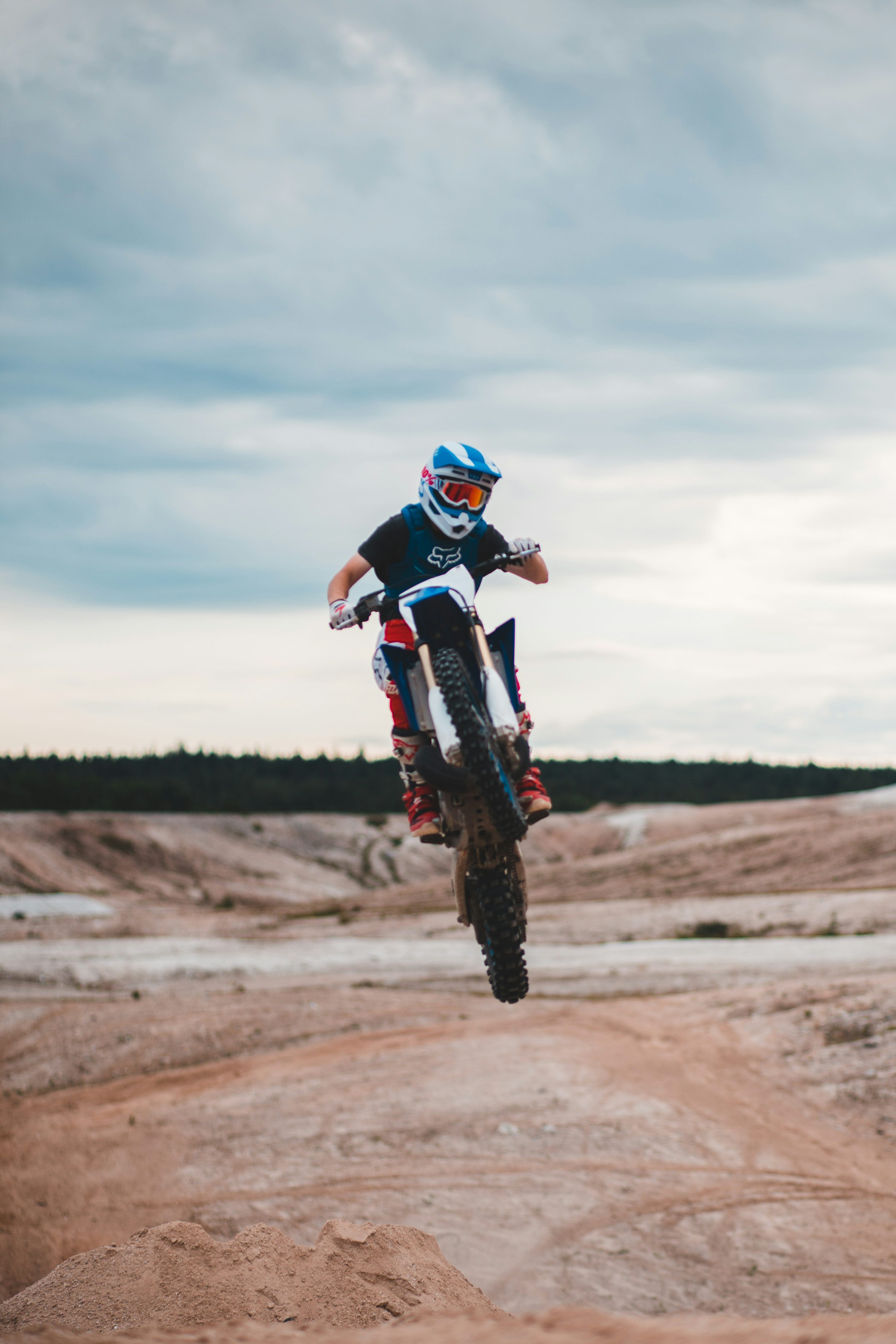 Man in blue and white motocross helmet