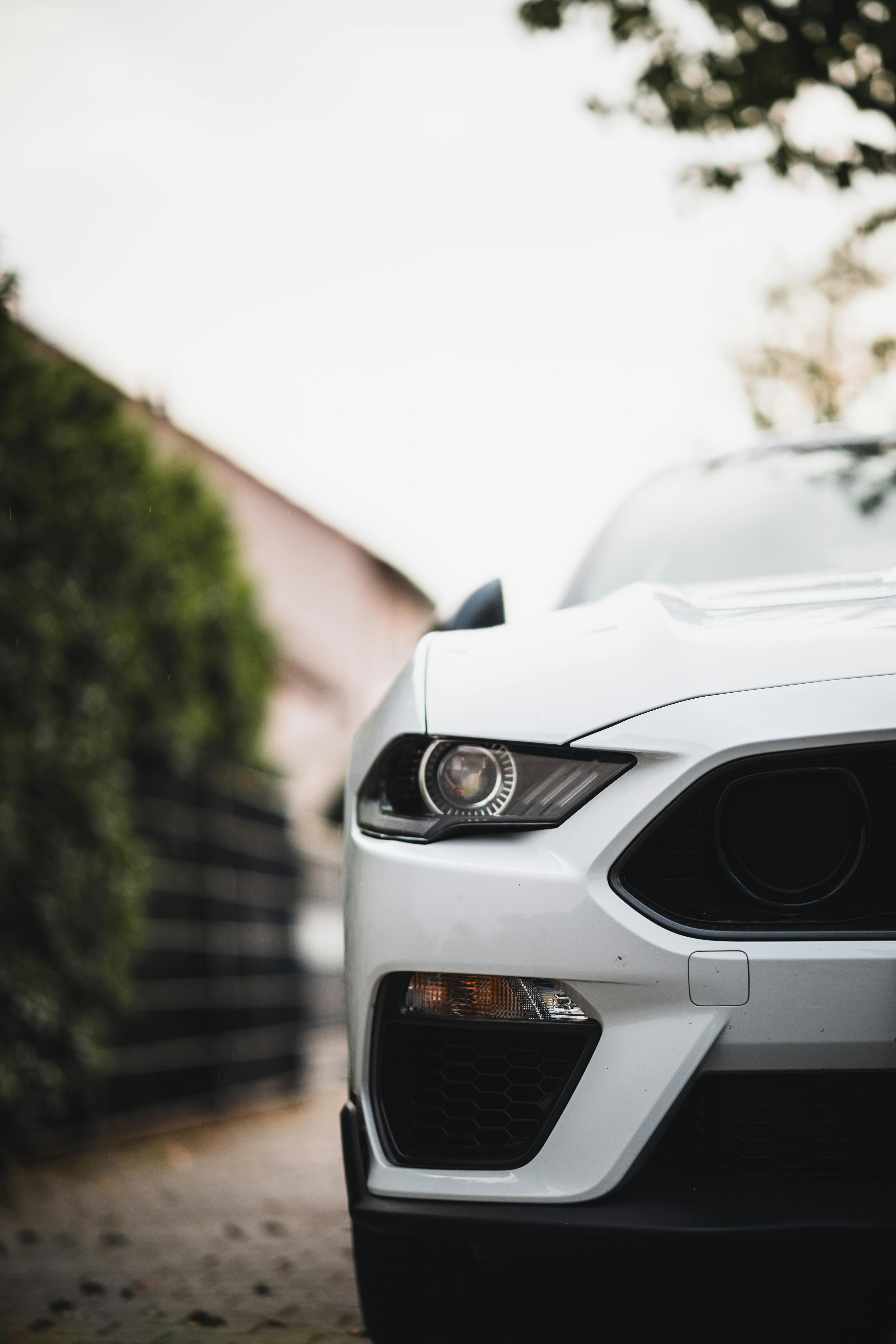 White Ford Mustang Parked in Driveway