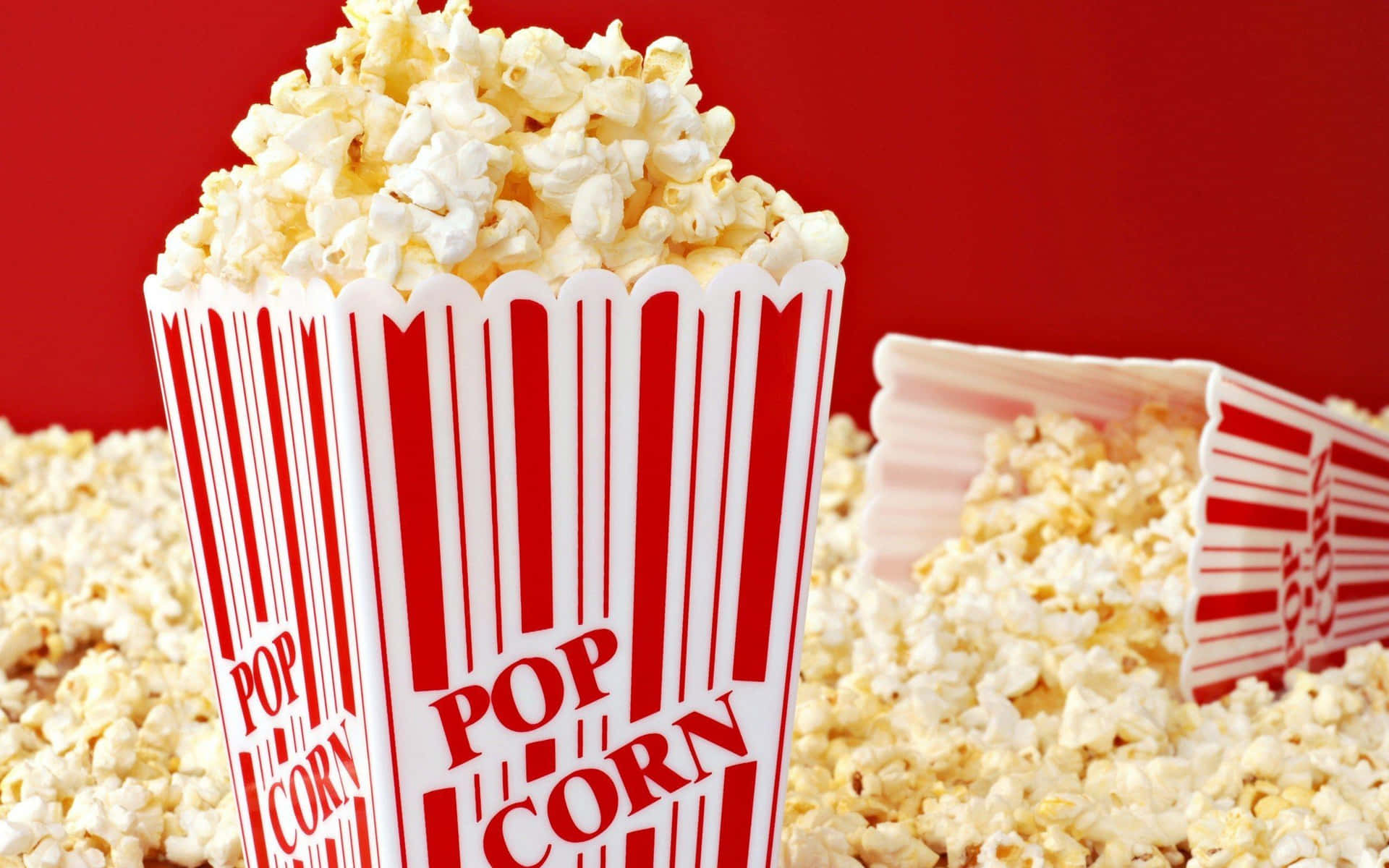 Overflowing Popcorn Box Red Background