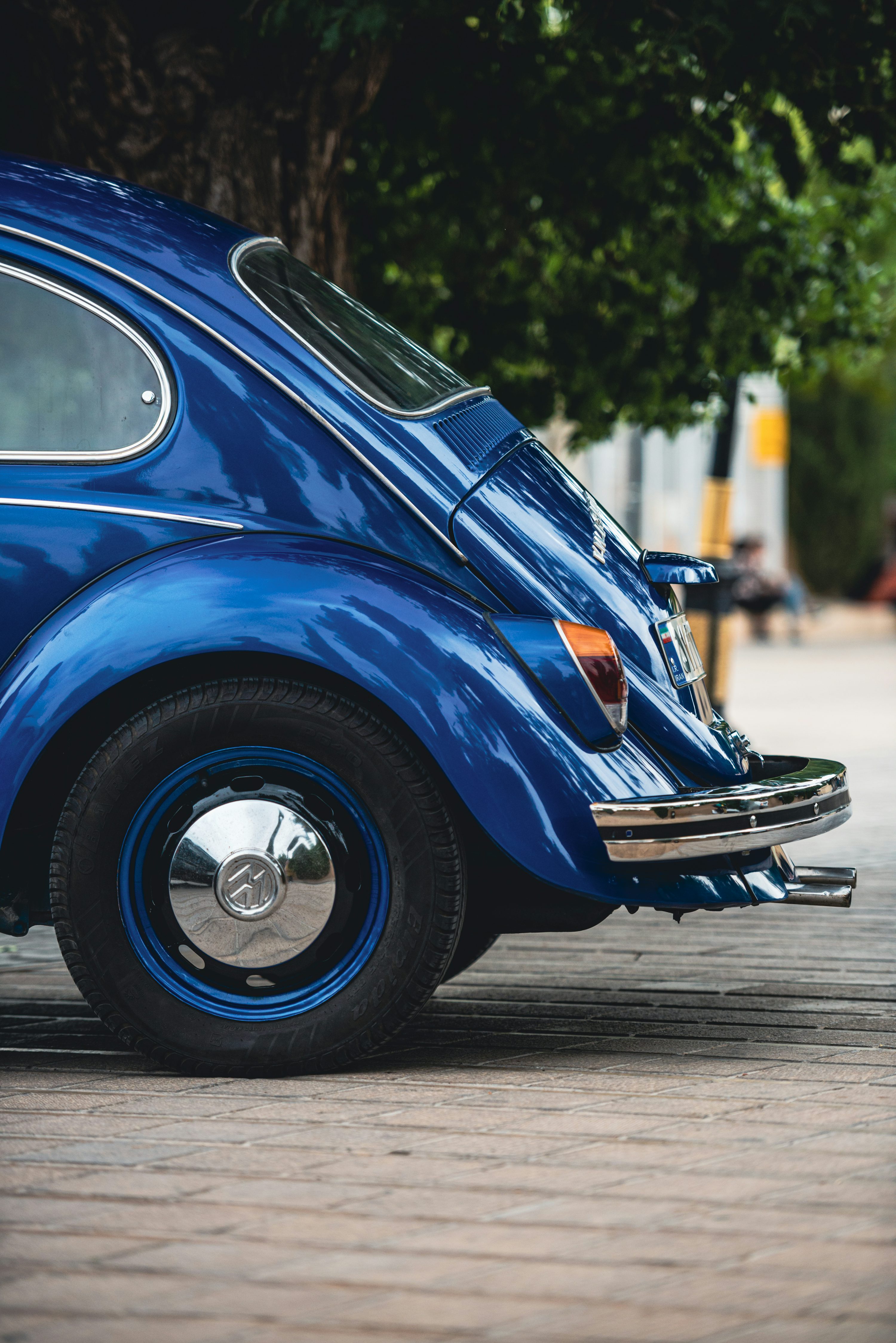 A blue vw bug parked on the side