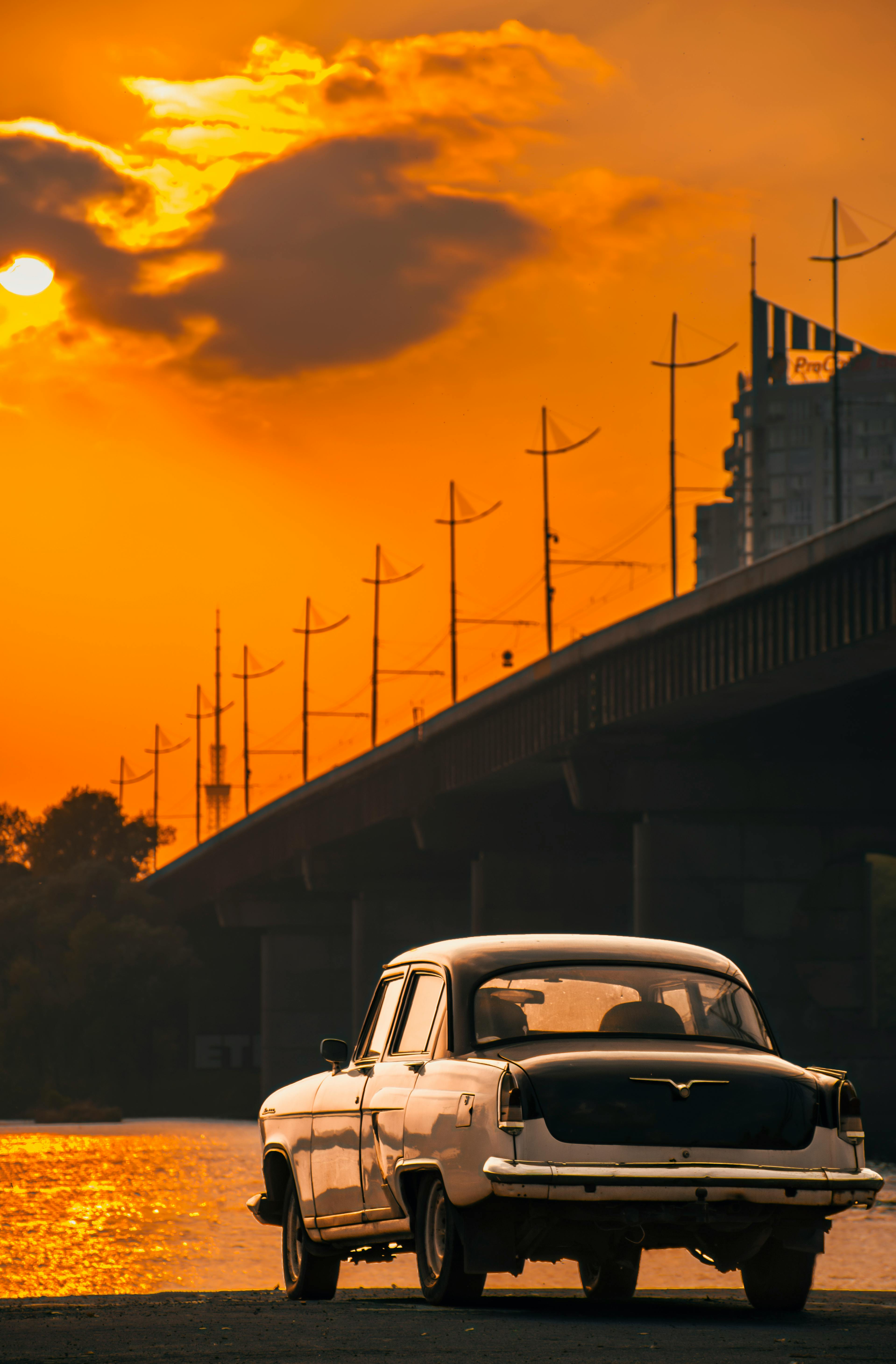 White Vintage Car Parked Near a Bridge