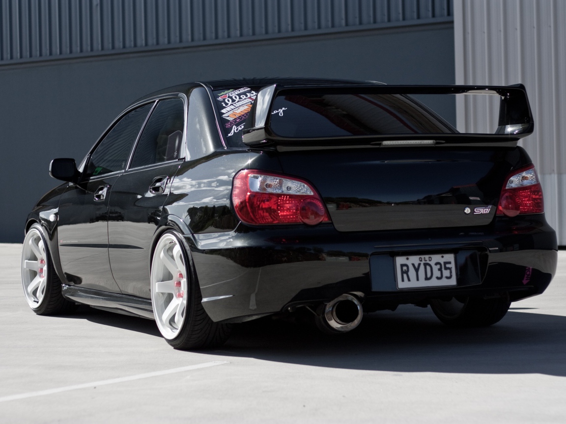Rear view on the black Subaru Impreza