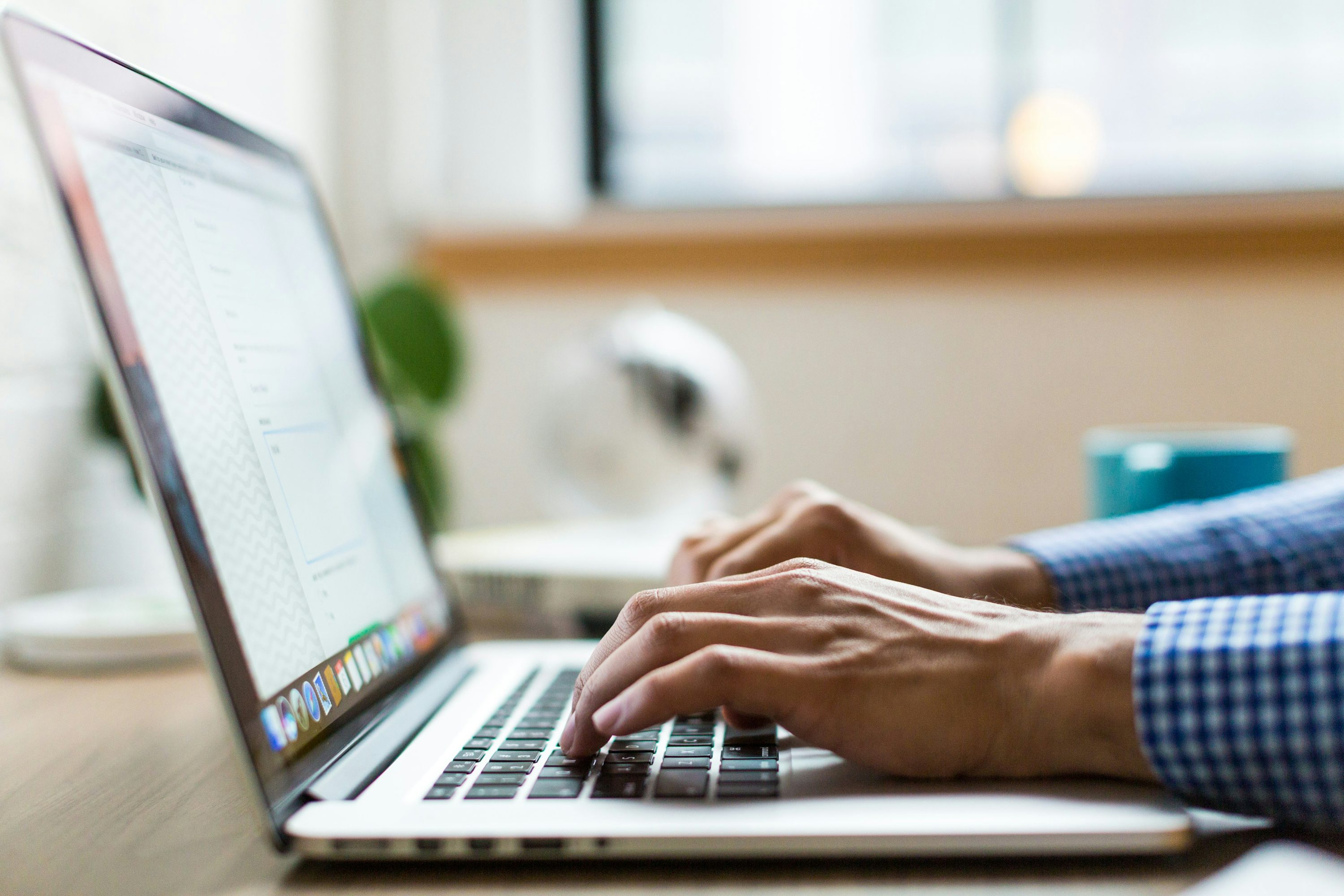 Person typing on silver MacBook photo