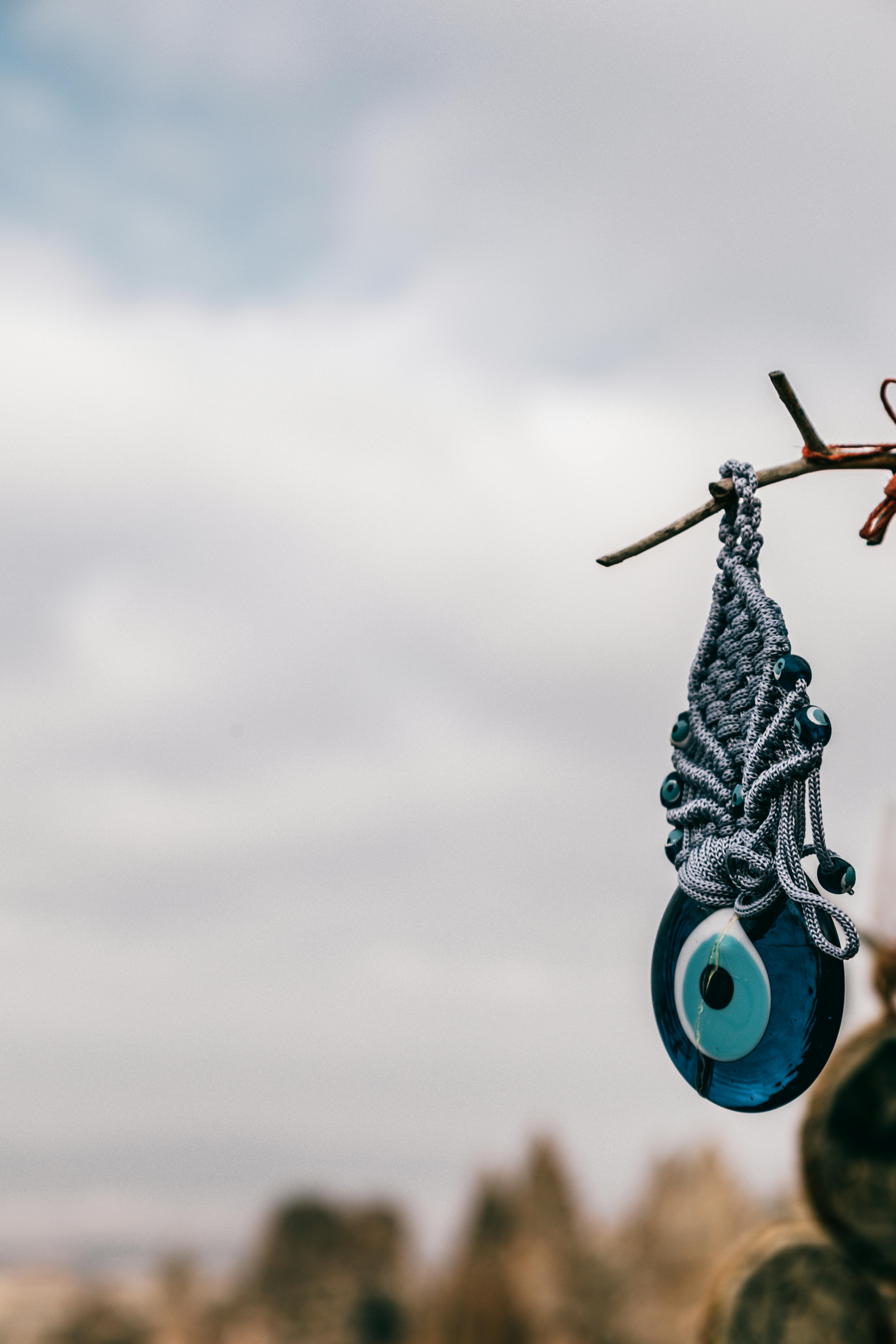 Glass amulet hanging on tree branch