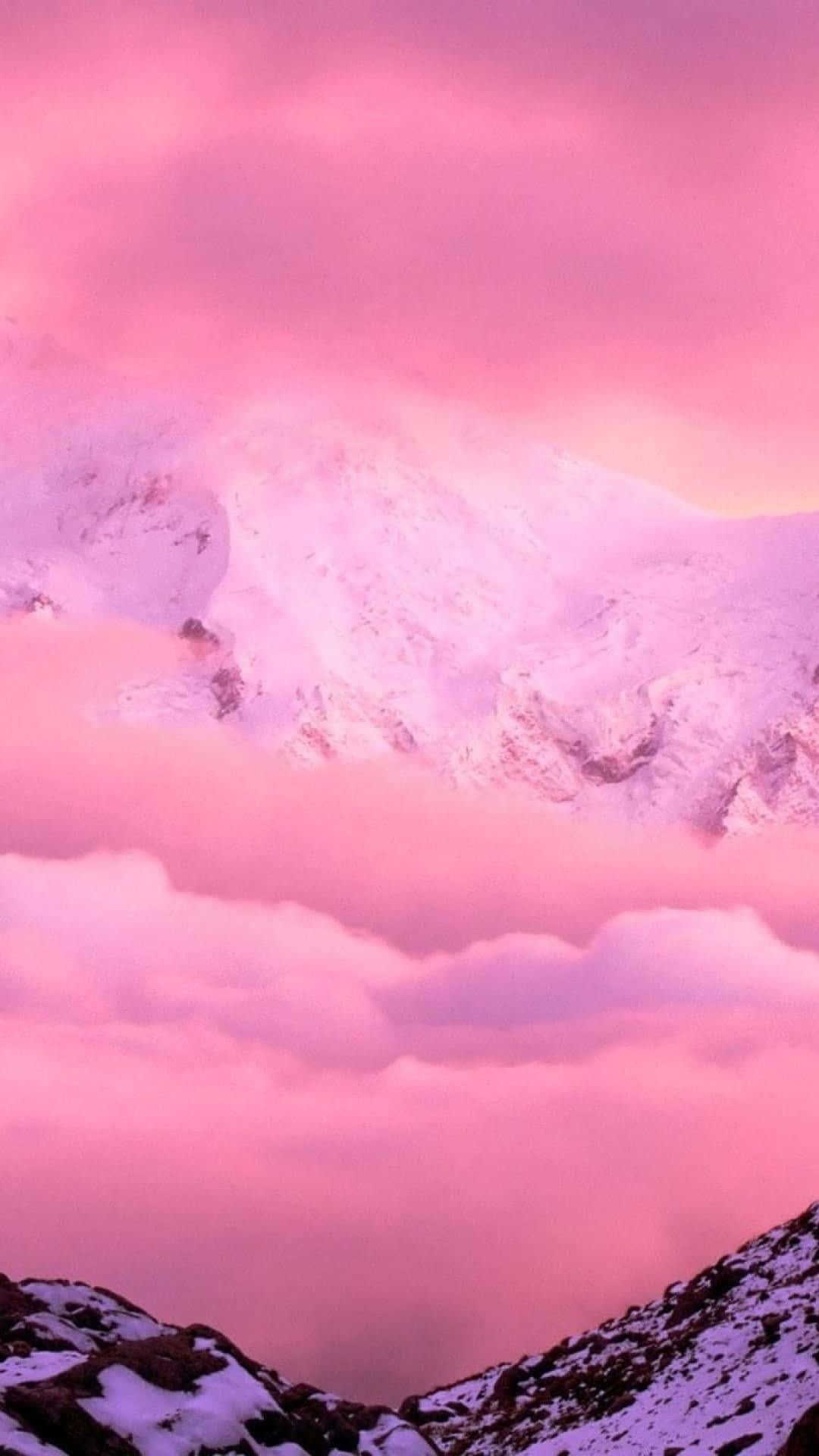 A Pink Sky With Clouds Over A Snow