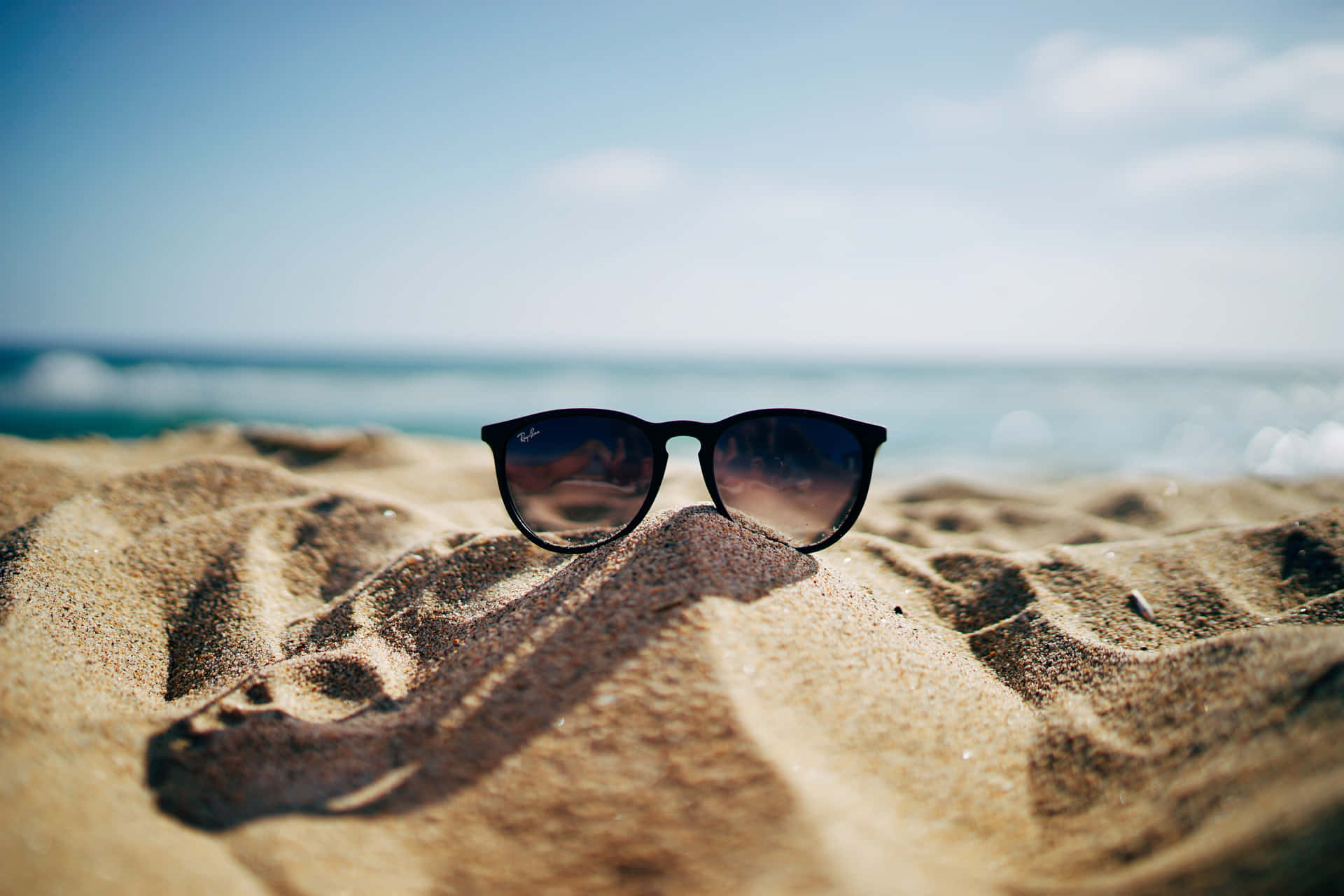 Sunglasses On The Sand Wallpaper