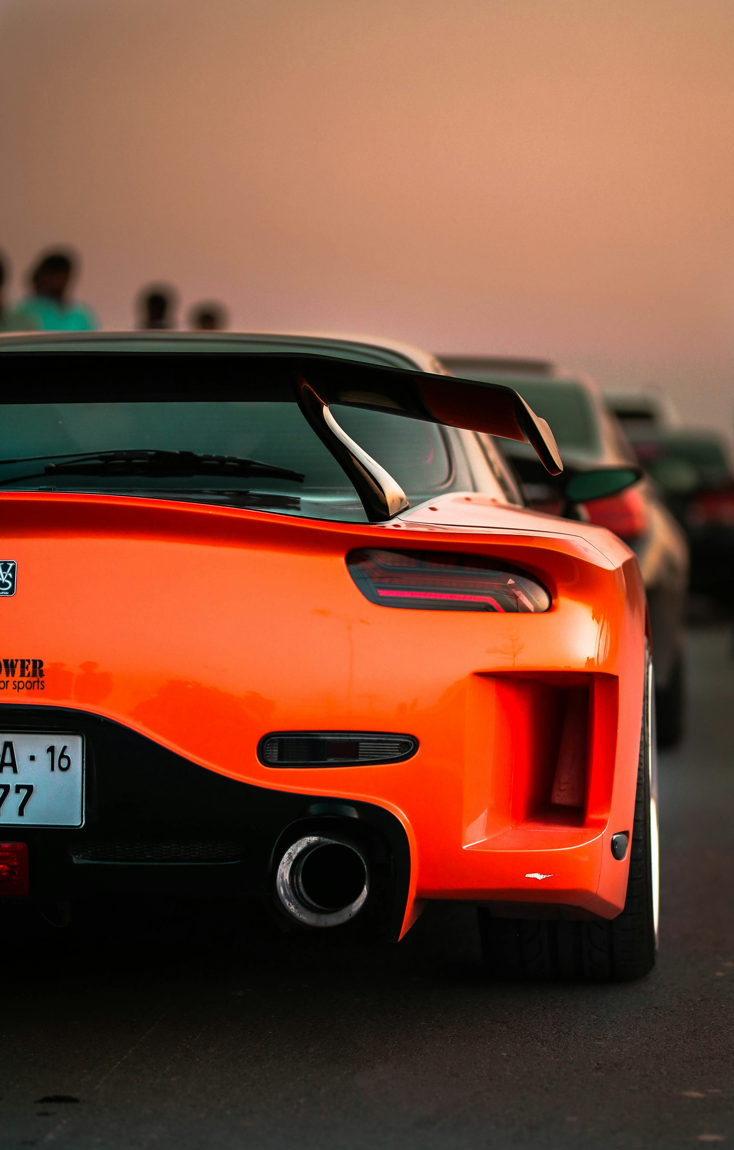 An orange sports car parked in a