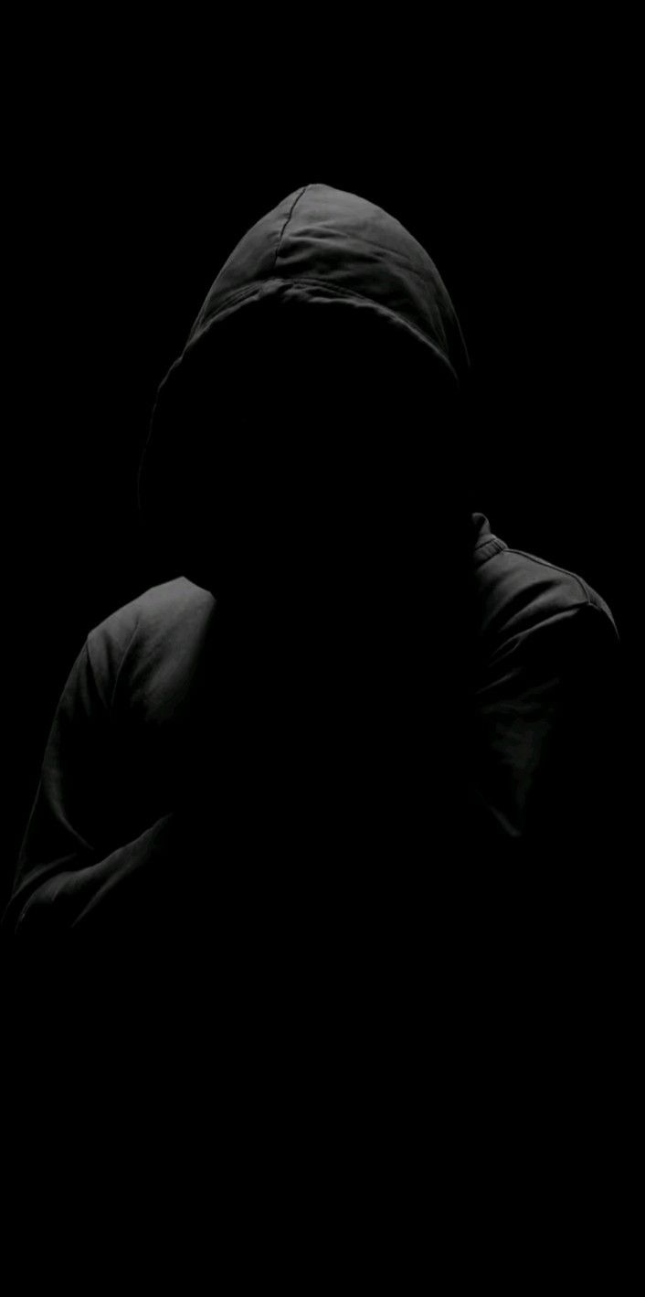 A man wearing black hoodie in a dark black background hacker wallpaper