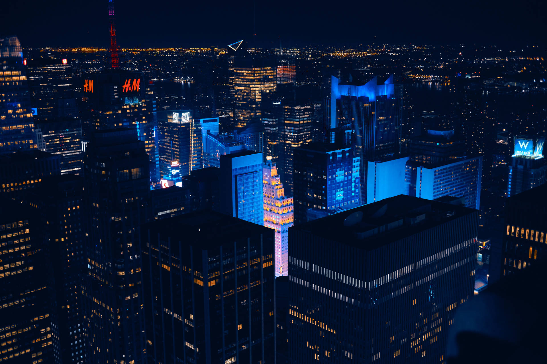 Download The bustling city of New York glows with blue light. Wallpaper
