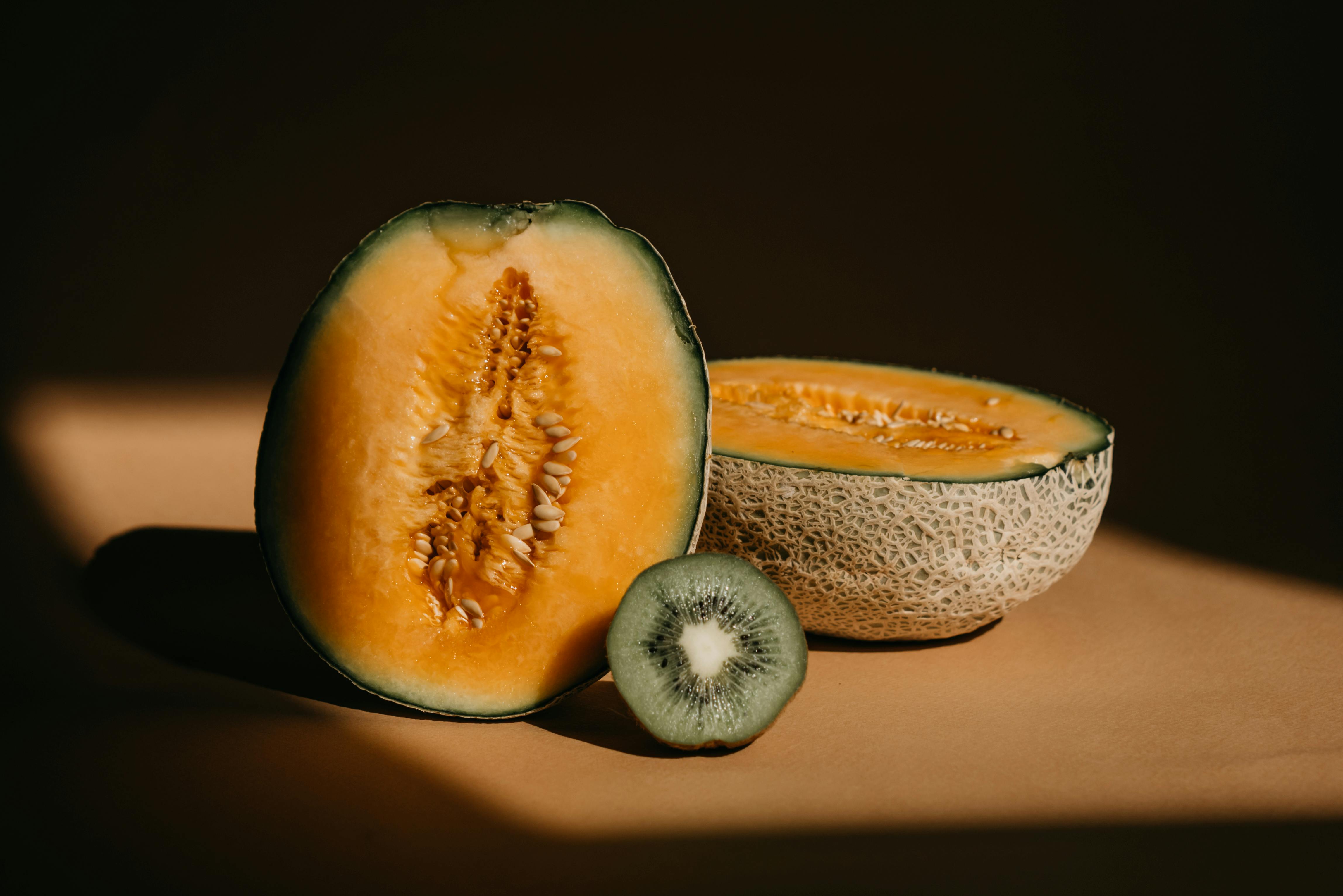 A Close Up Shot Of A Sliced Melon And Kiwi · Free