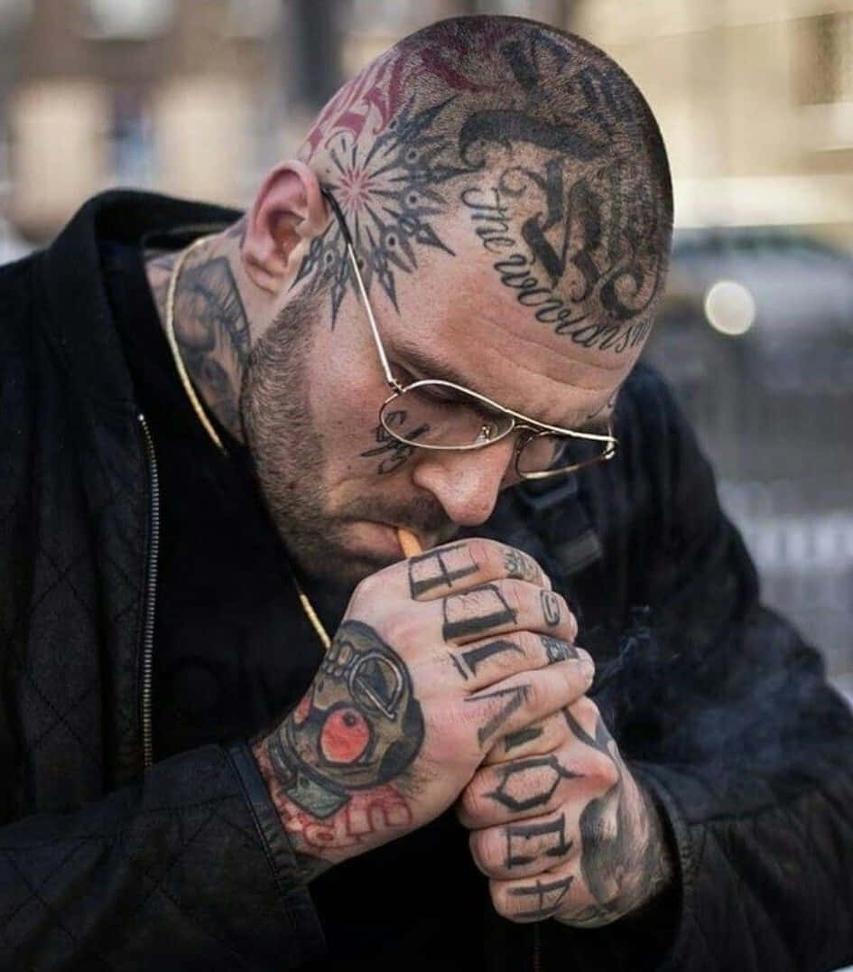 Download A Man With Tattoos Smoking A Cigarette