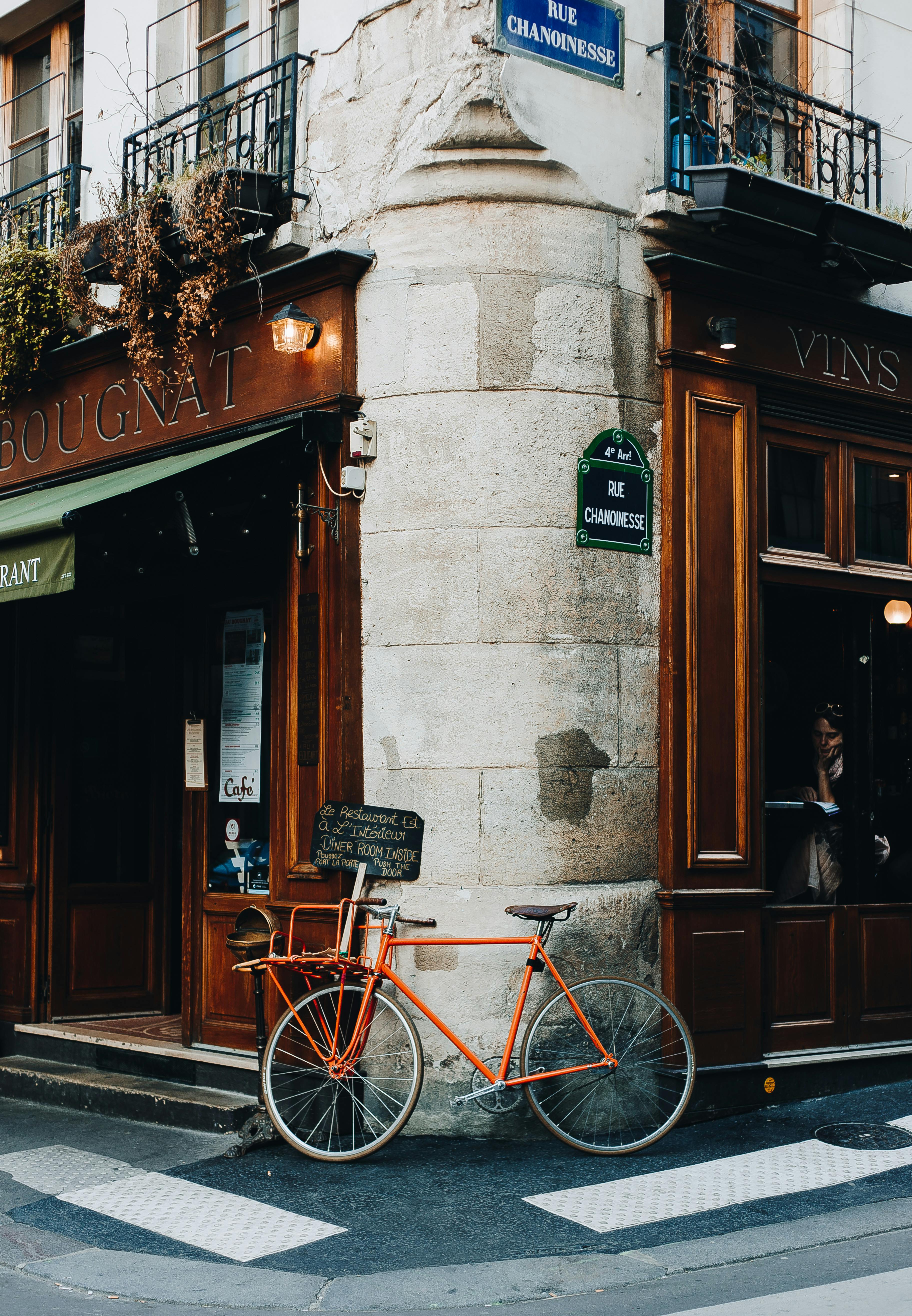 A Red Bike Parked on Street Corner · Free