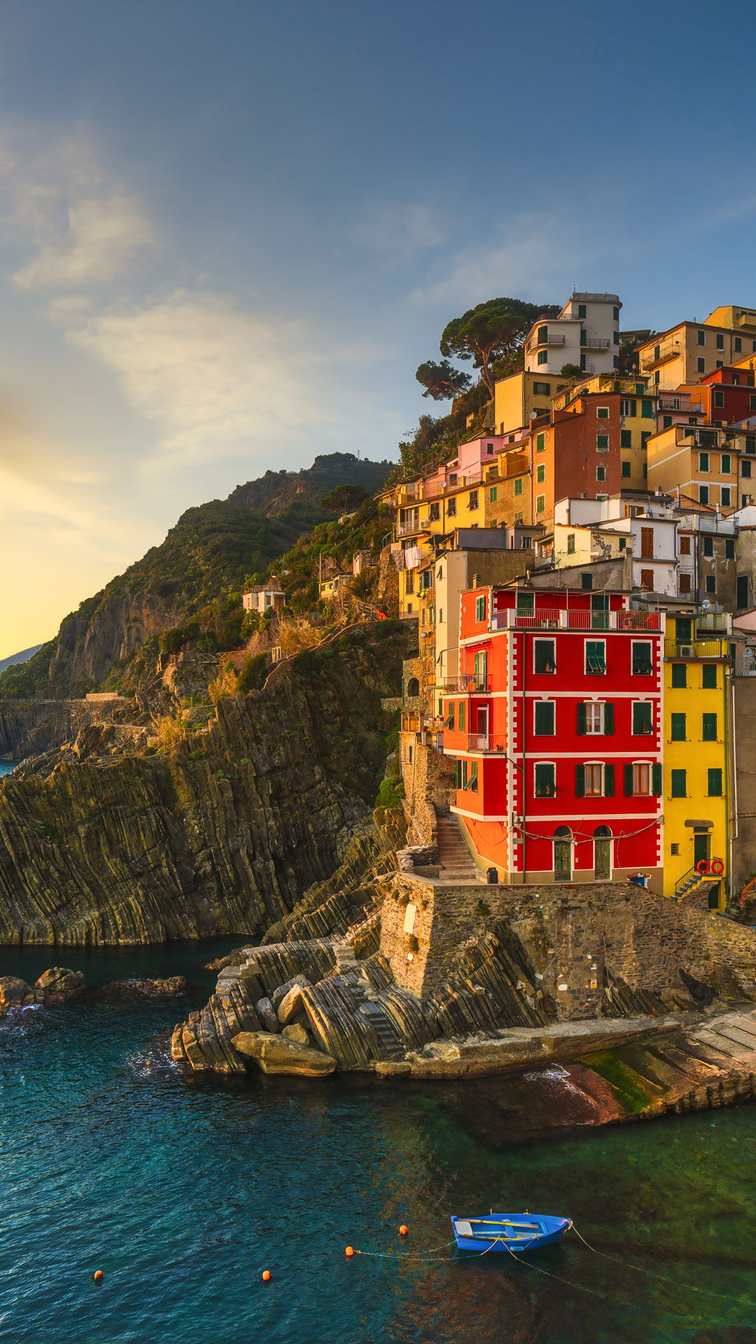 Riomaggiore town, cape and seascape at sunset, Cinque Terre National Park, Liguria, Italy. Windows Spotlight Image