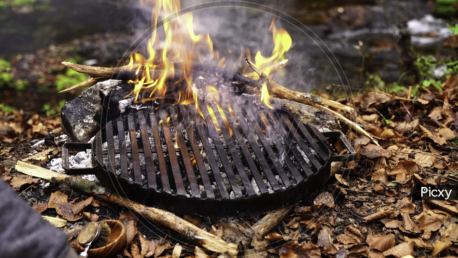 Image of Blank Flaming BBQ Charcoal Grill, Closeup. Hot Barbeque Grill Ready Cooking Food On Cast Iron Grate. Concept For Cookout, Barbecue Party At Garden Or Backyard. Grill With Bright Flames Black