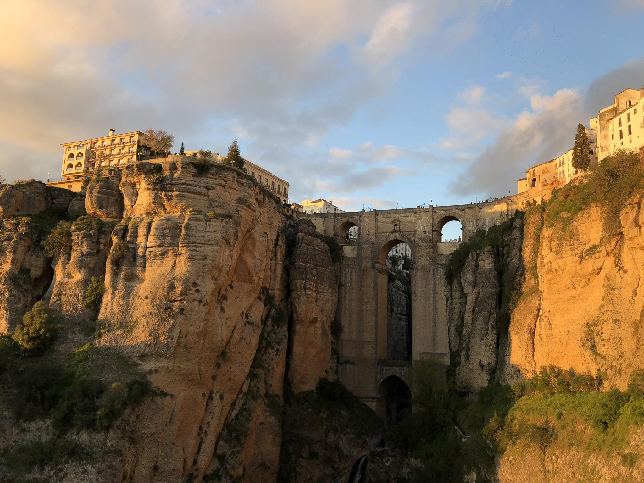 The sun setting on Puento Nuevo in Ronda, Spain. This was the most beautiful place I've ever been. Go in Spring to enjoy the wildflowers