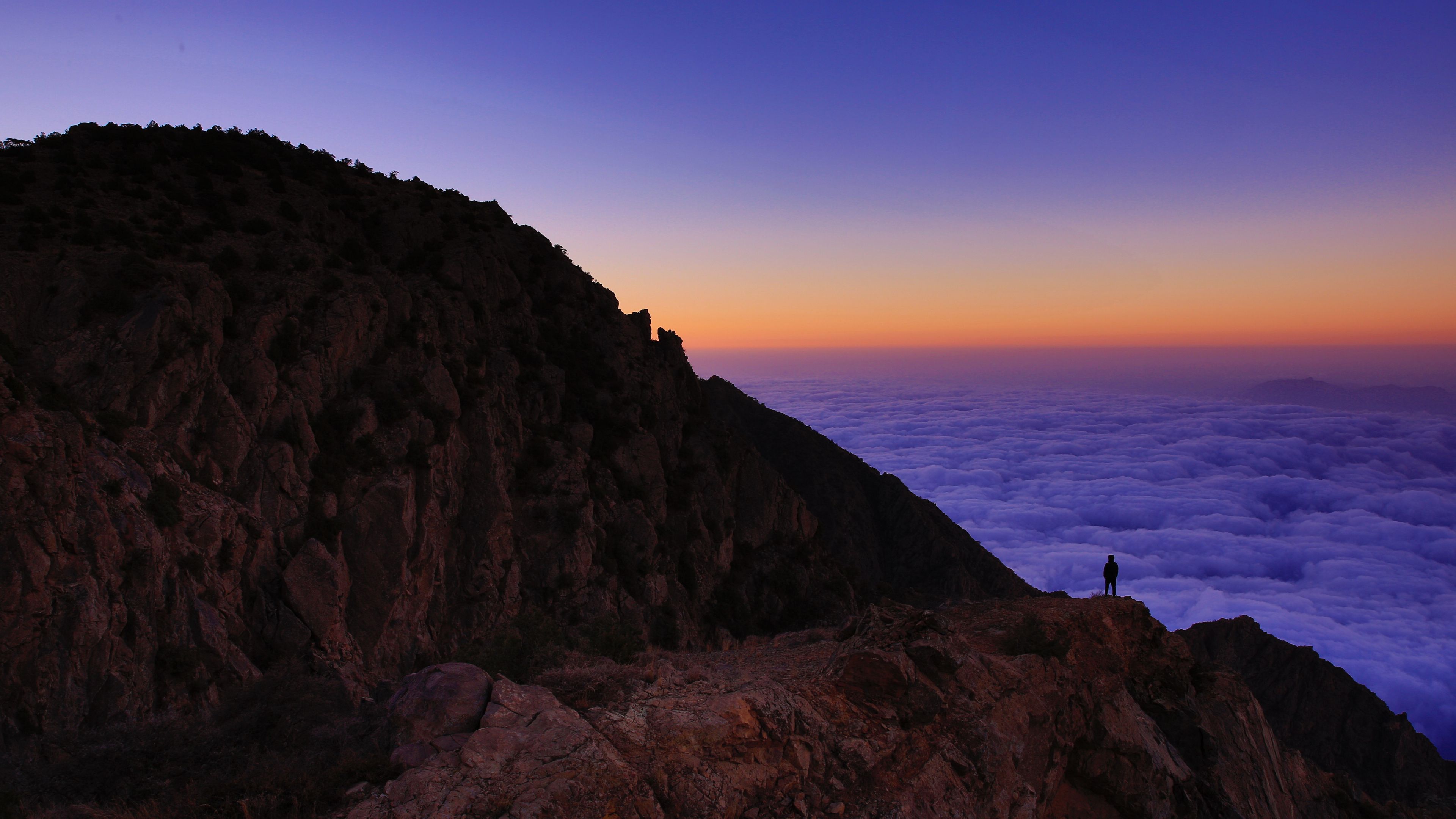 Download wallpaper 3840x2160 mountain, man, loneliness, clouds, al bahah, saudi arabia 4k uhd 16:9 HD background