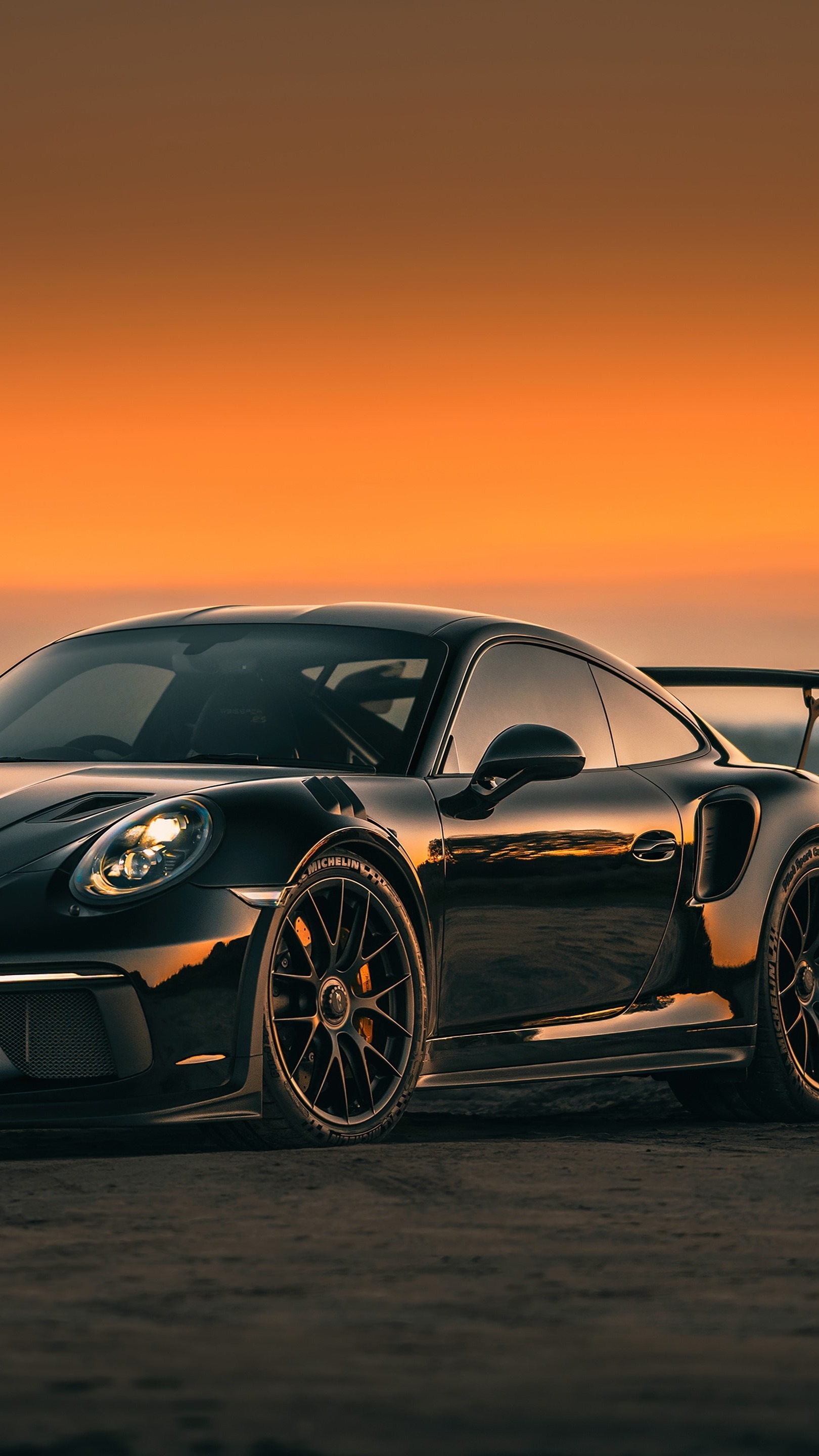 Sunset Embrace with a Black Porsche 911 GT3 Sports Car