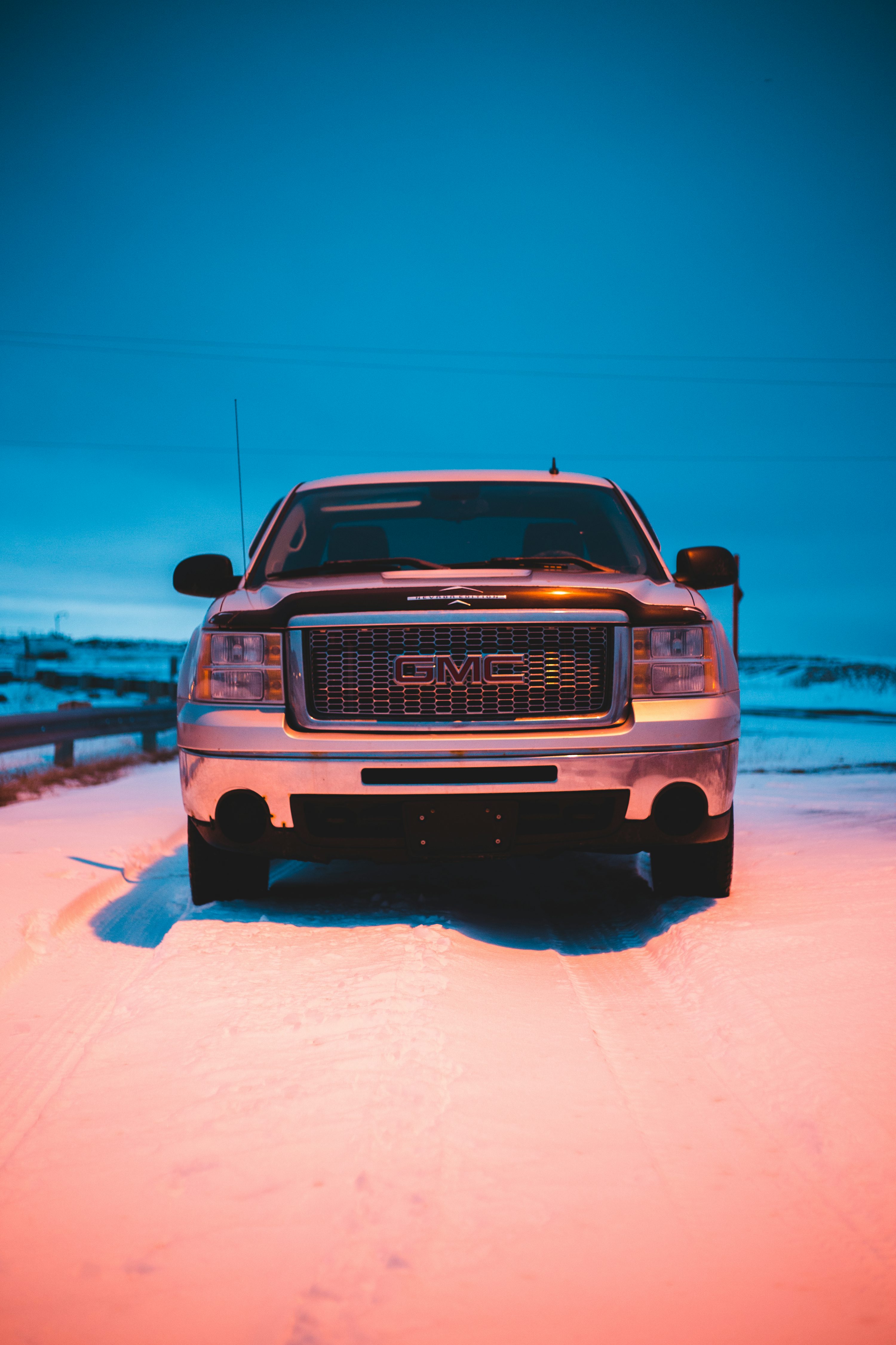 Parked black GMC truck on snowfield photo