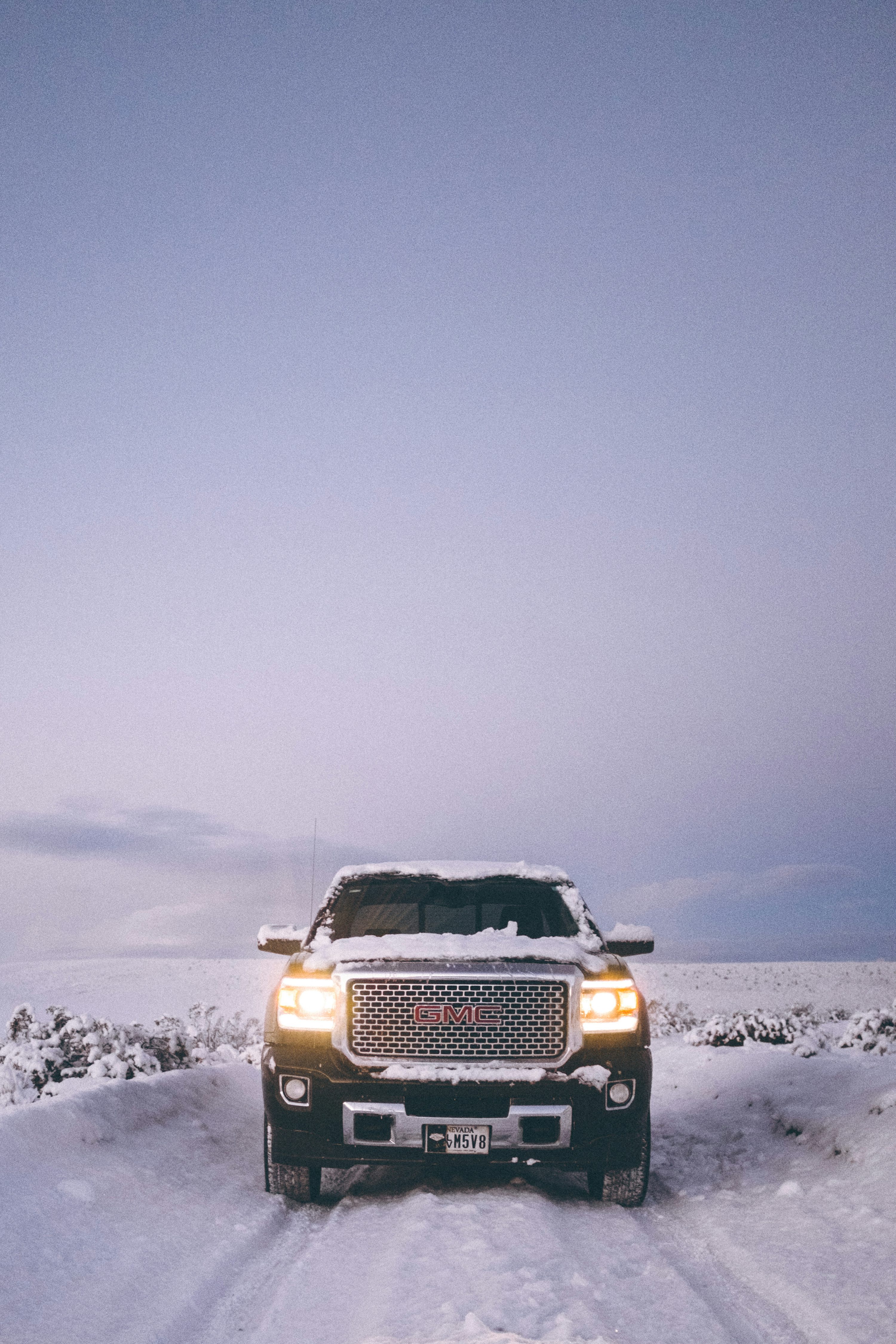 Black car travelling on snow photo