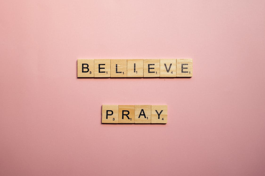 A Believe and Pray Words of Encouragement on Pink Surface · Free