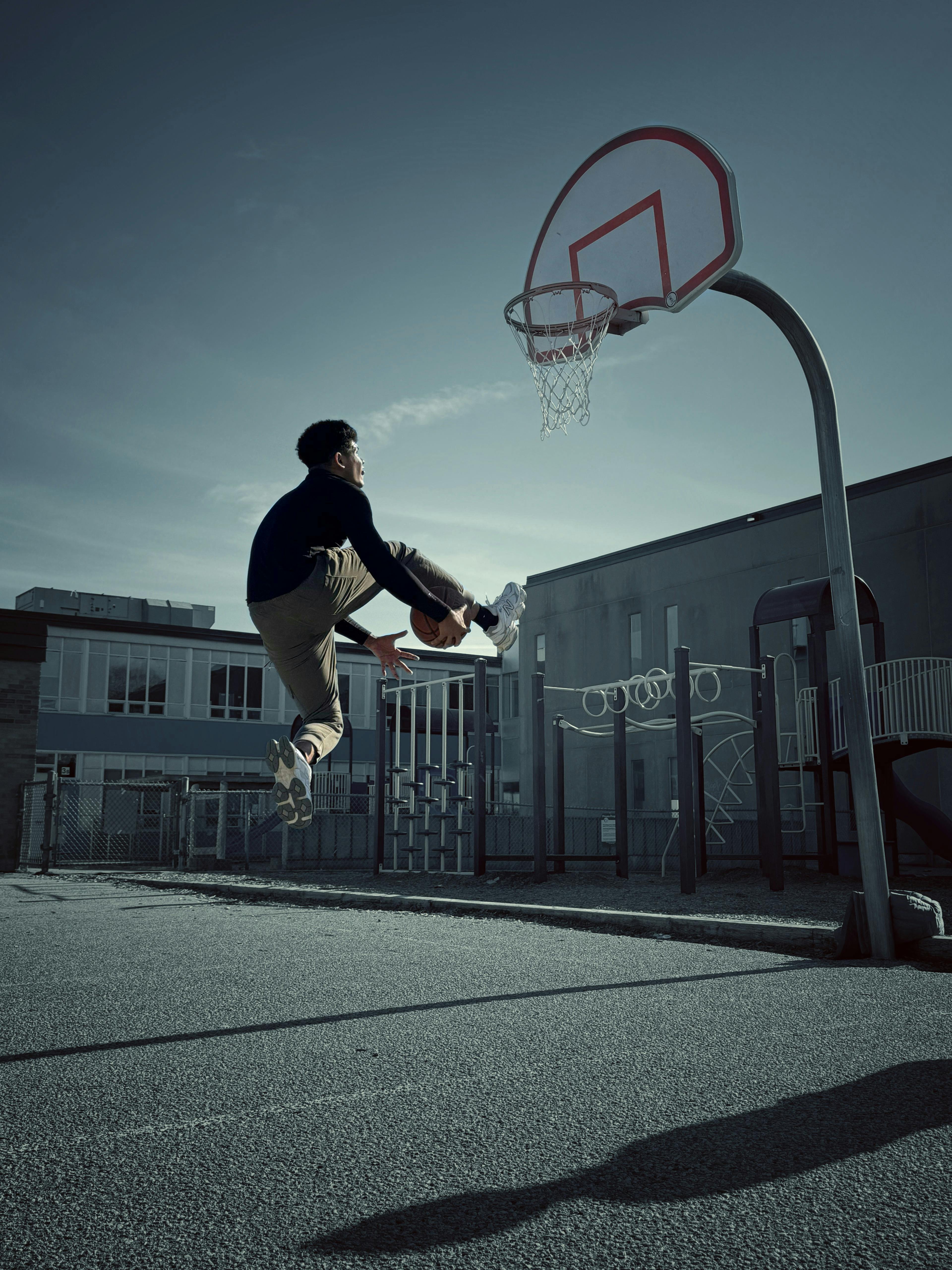 Man Jumping While Playing Basketball on Court · Free