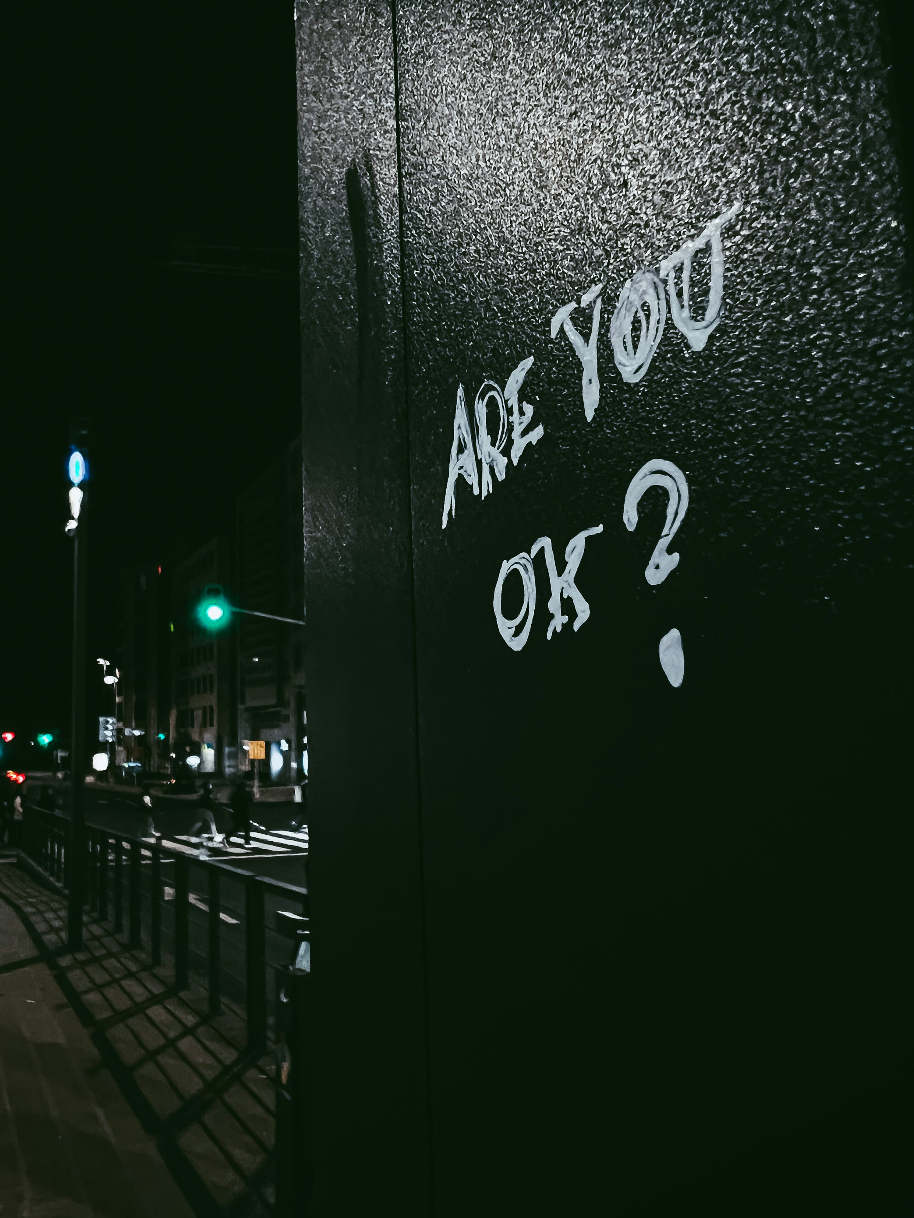 Graffiti on the side of a building that says are you ok? photo