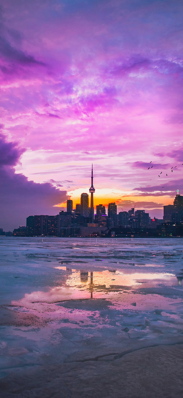 Purple Sunset Over City Buildings 4K Phone Wallpaper