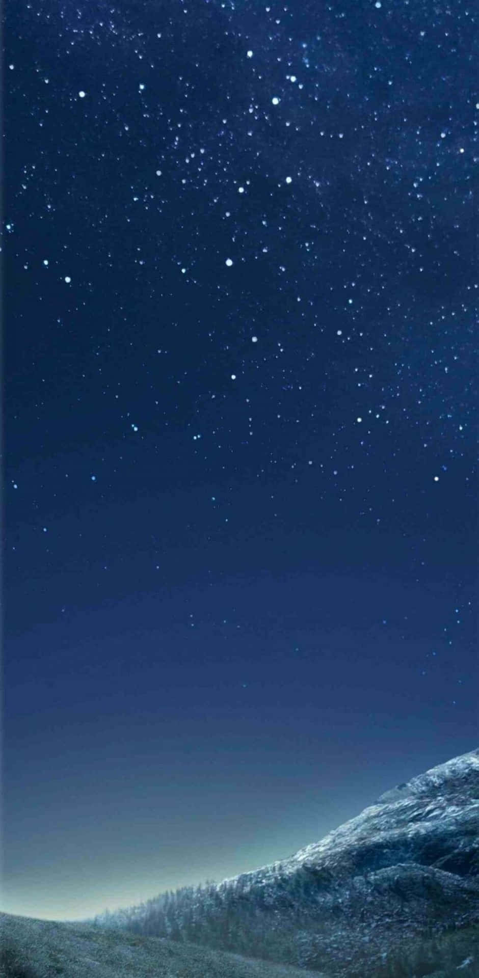 Download A Night Sky With Stars And A Mountain Wallpaper