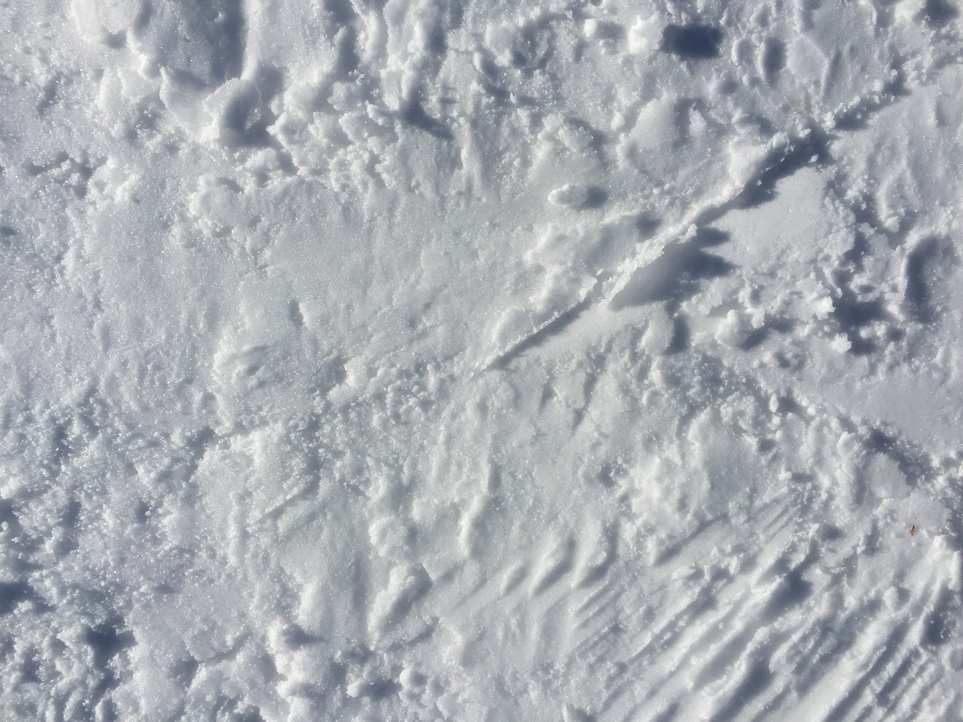 Snowy texture with grooves, crumbles, bumps, and caverns